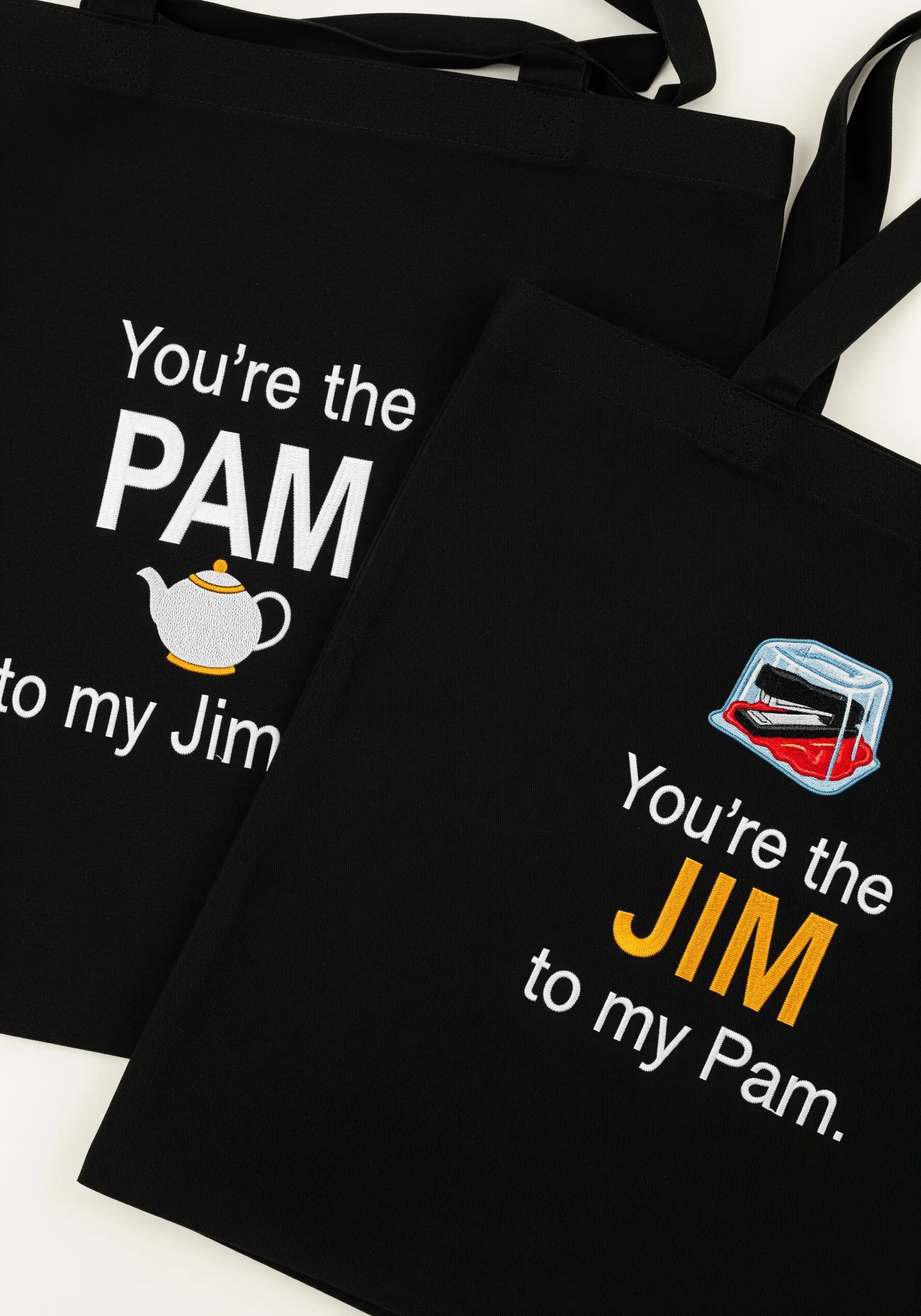 Black tote bags with 'The Office' TV show references: 'You're the Pam to my Jim'.