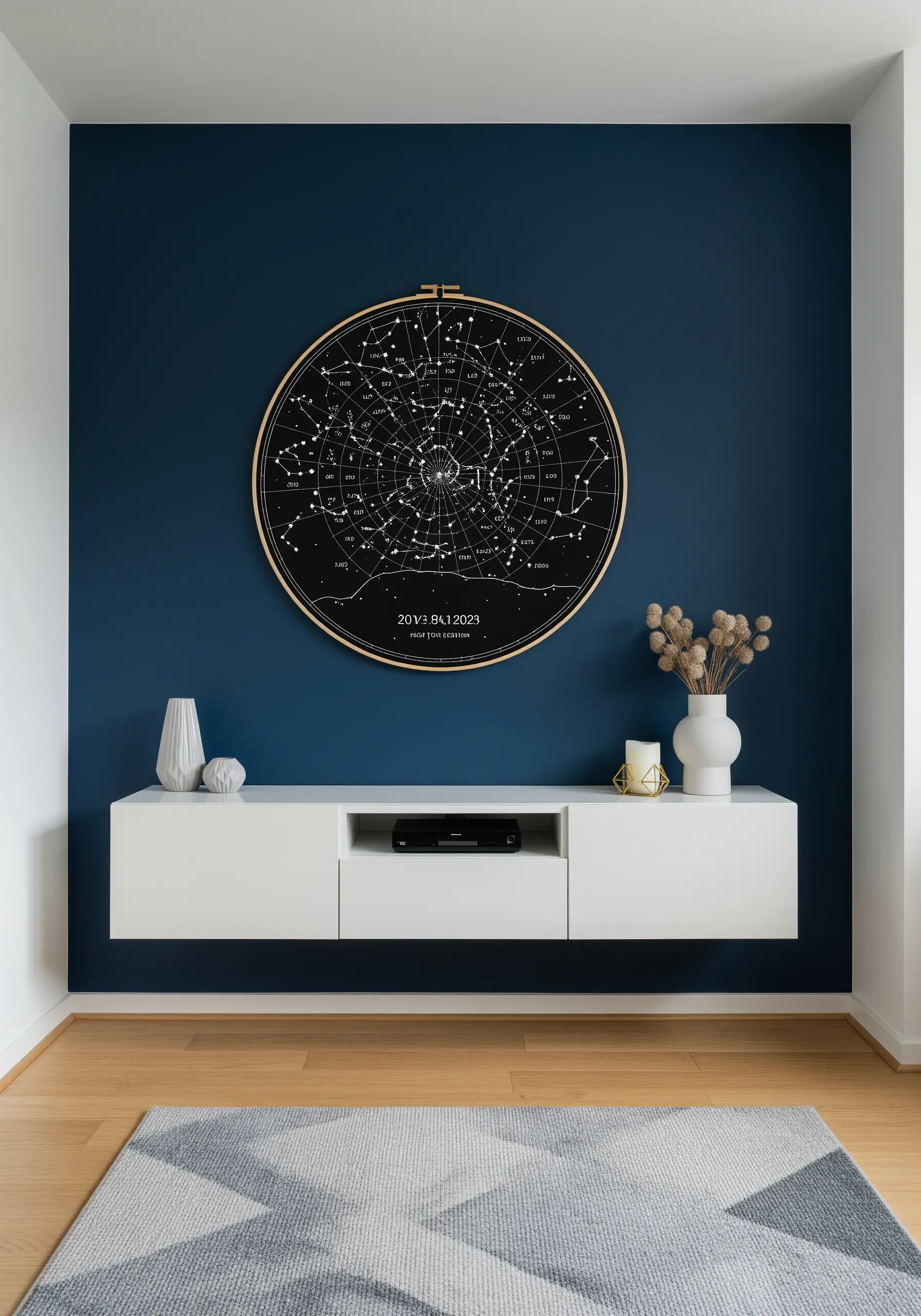 A large embroidery hoop with a black fabric star chart hanging on a dark blue wall.