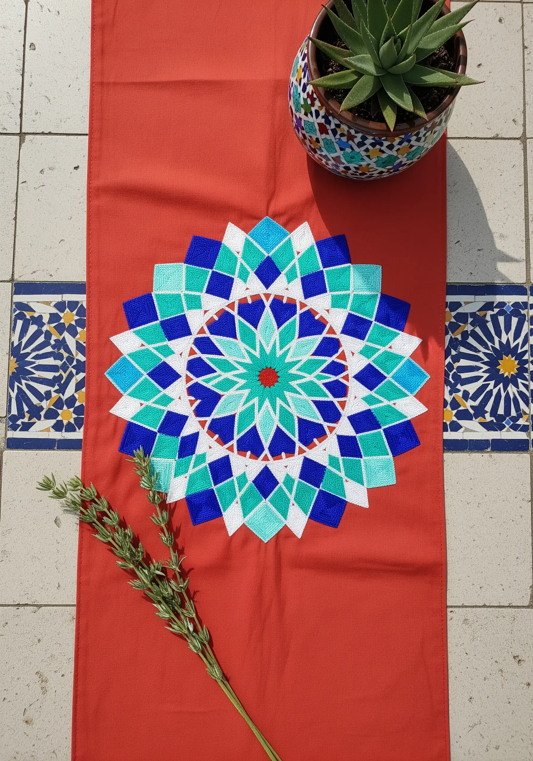 A colorful geometric mandala inspired by Moroccan tiles, stitched on a red runner.