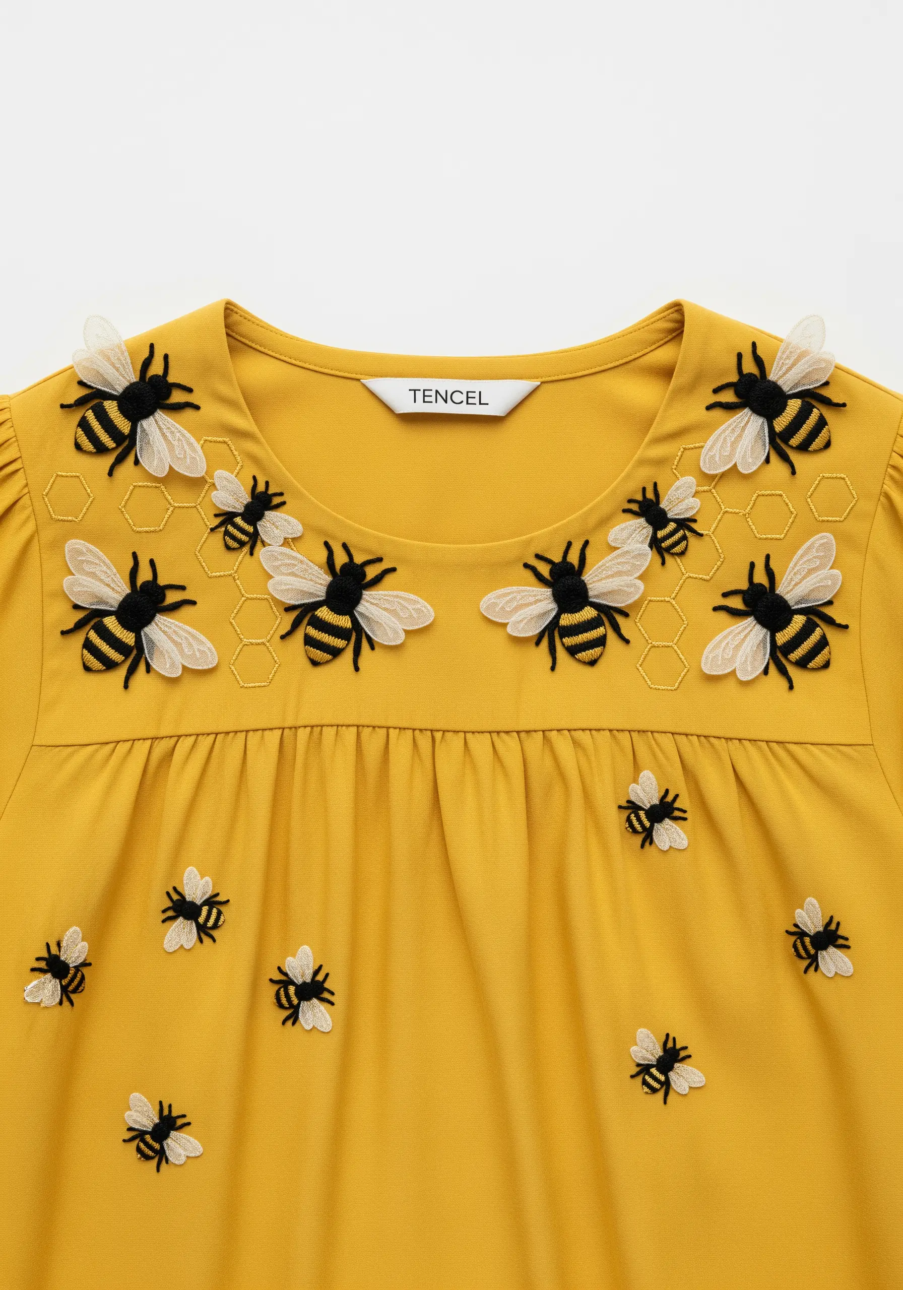 A swarm of bees embroidered on a yellow shirt, with delicate, sheer 3D wings.