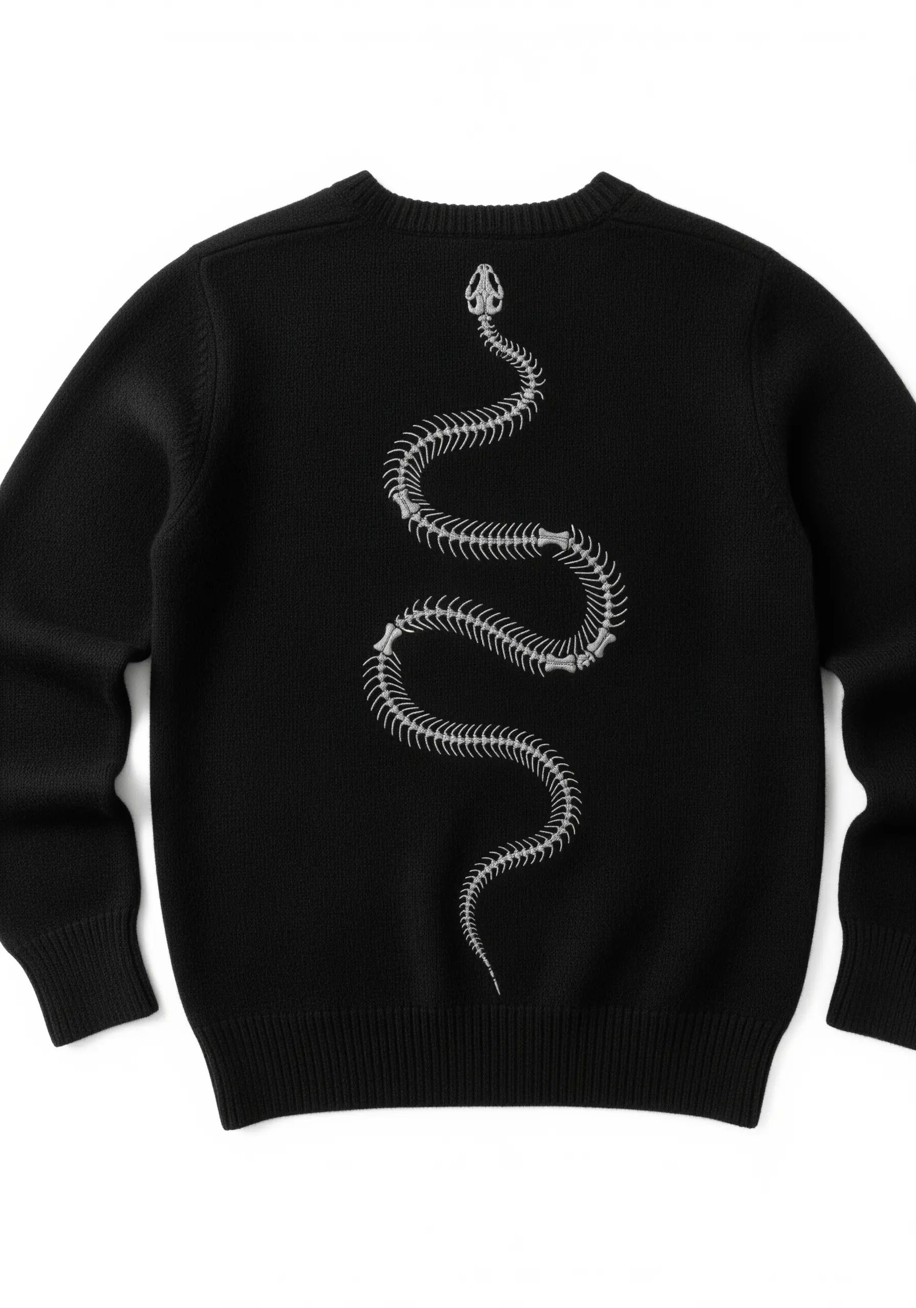 A long, curving snake skeleton embroidered in white thread down the back of a black sweater.