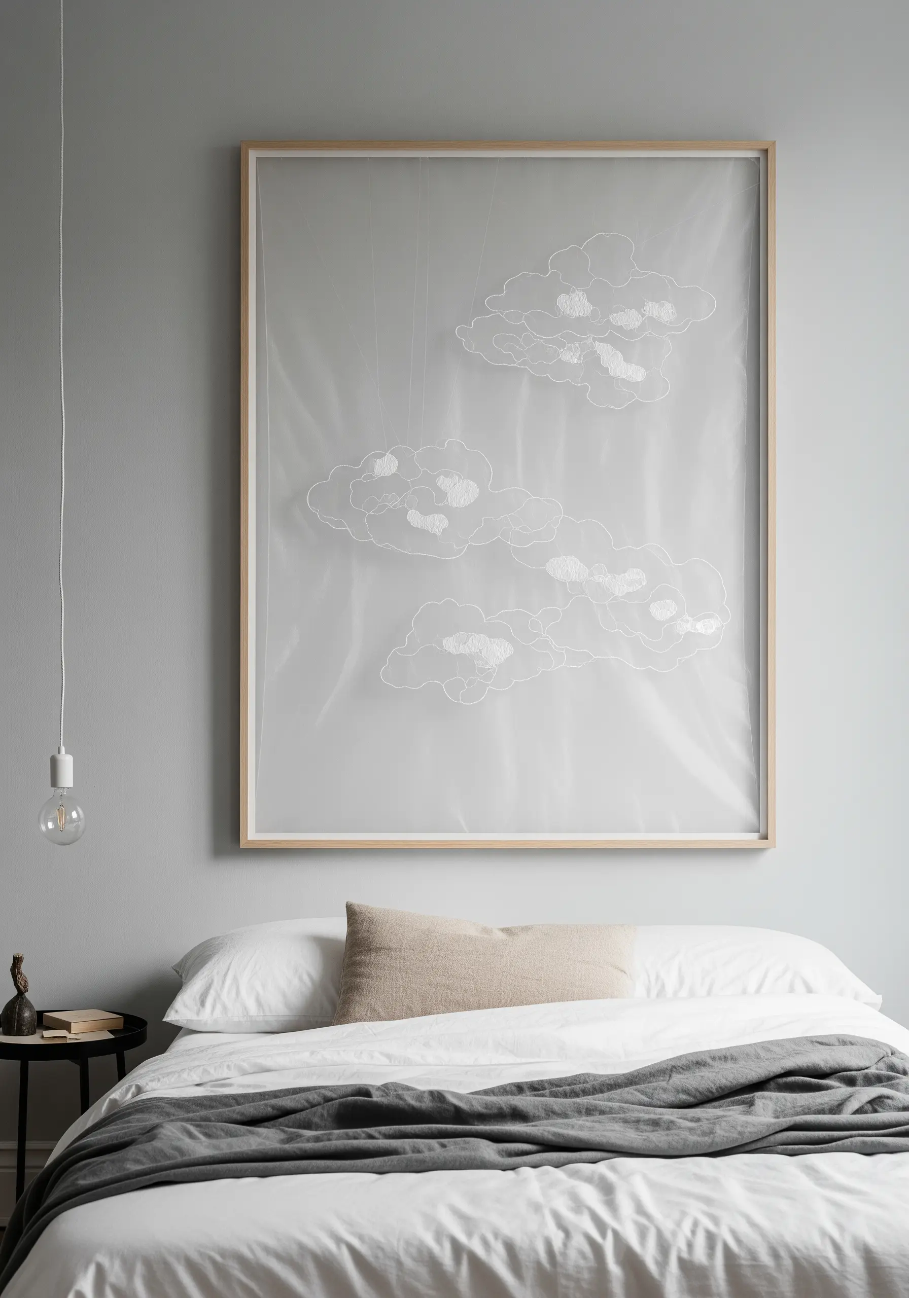 A framed artwork with white cloud outlines embroidered on layered sheer fabric, creating a 3D effect.