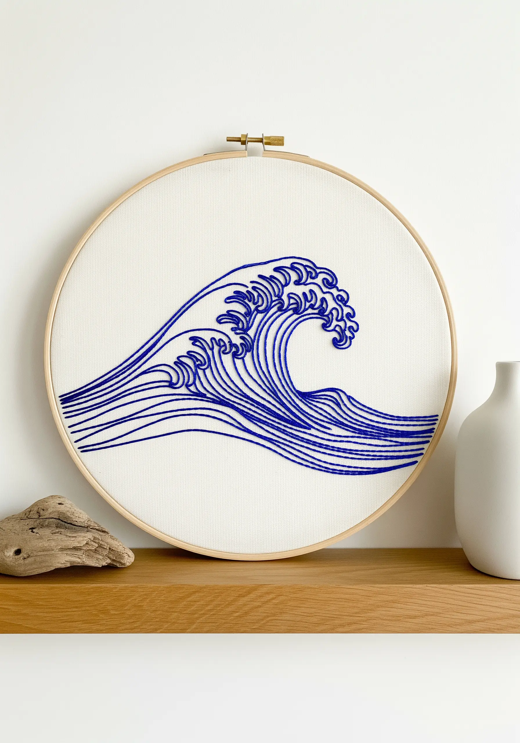 Japanese-style wave embroidered in blue thread with flowing, curved lines.