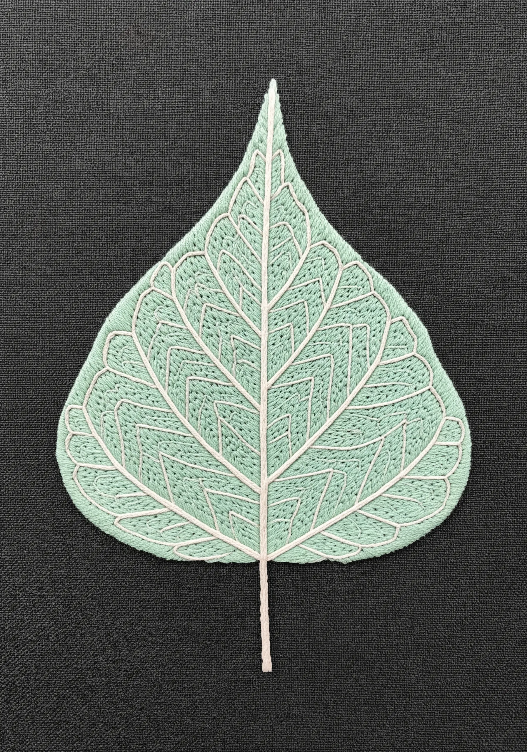 A mint green Bodhi leaf with white veins creating geometric sections of fill stitch.