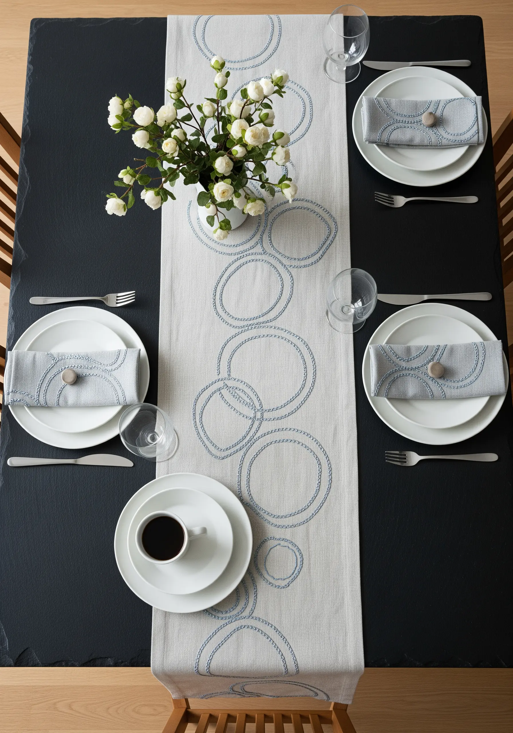 Overlapping circles stitched in blue thread on a long, light-colored table runner.