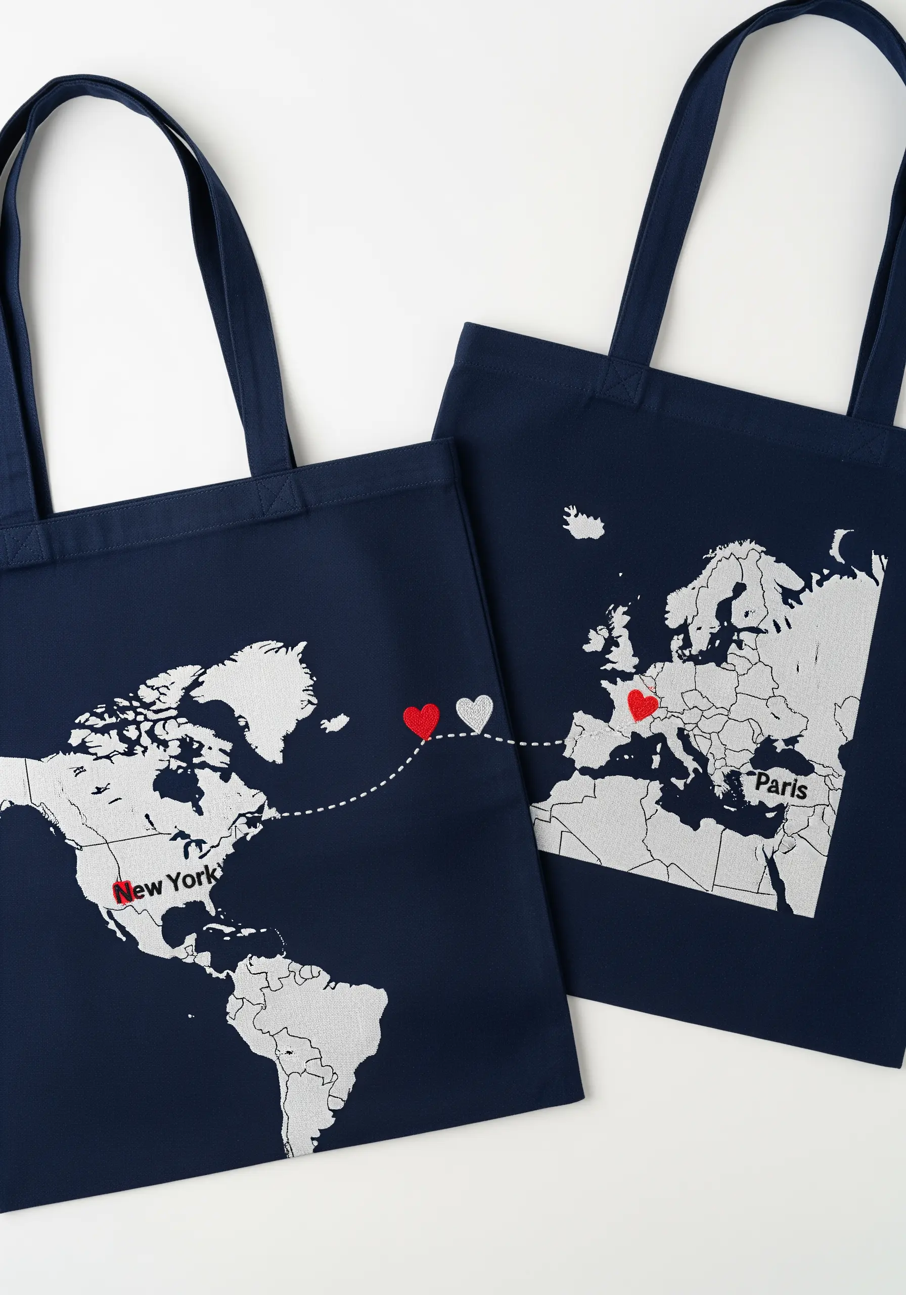 Navy tote bags with appliquéd world maps showing a connection between two cities.