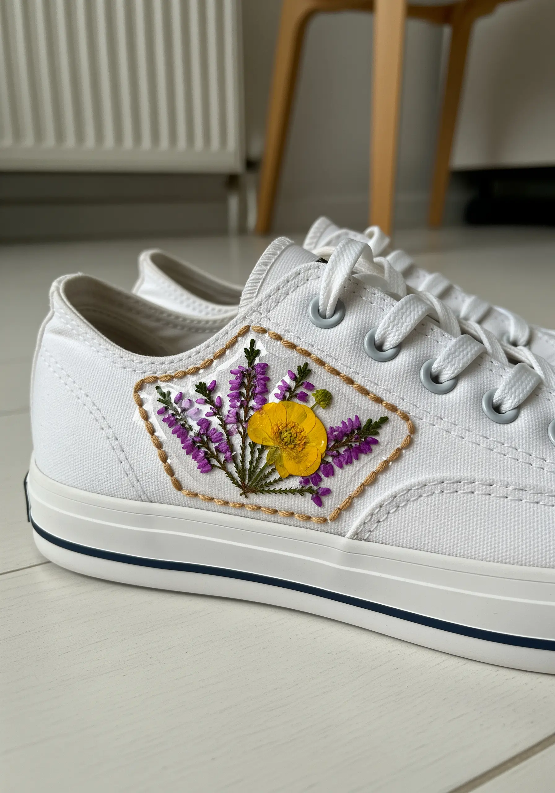 White canvas sneakers with a custom patch of pressed lavender and a yellow flower.