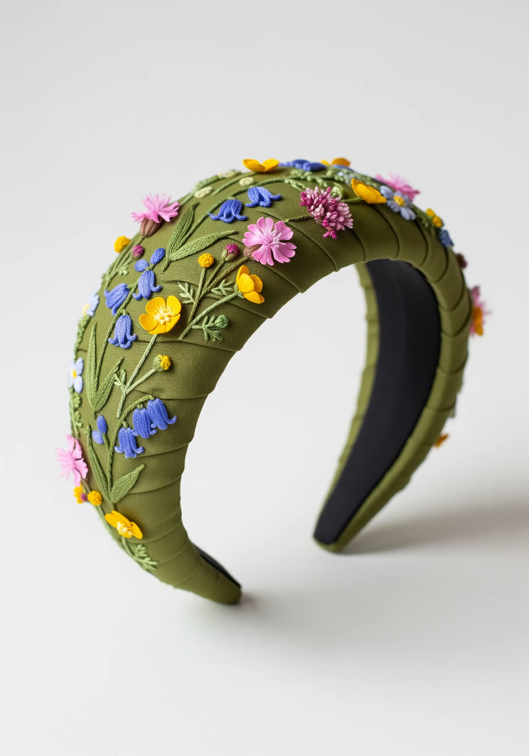 An olive green headband intricately decorated with 3D embroidered and ribbon-stitched wildflowers