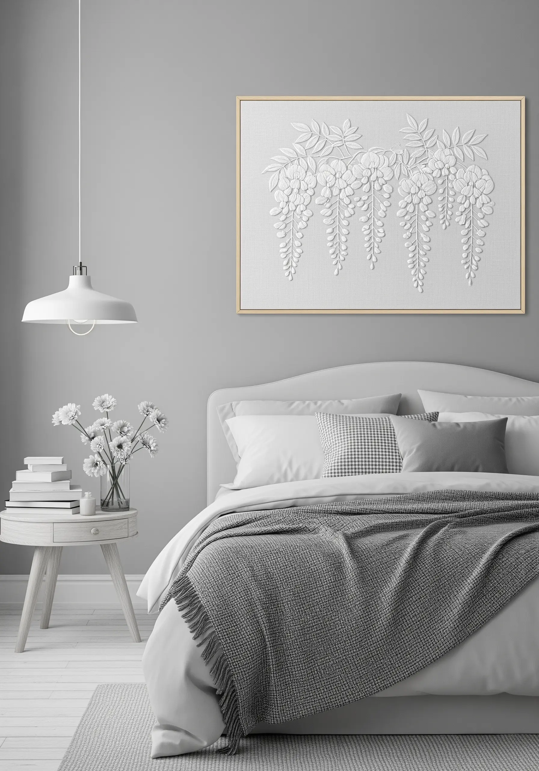 A framed white-on-white embroidery of wisteria flowers, showcasing textural stitchwork.