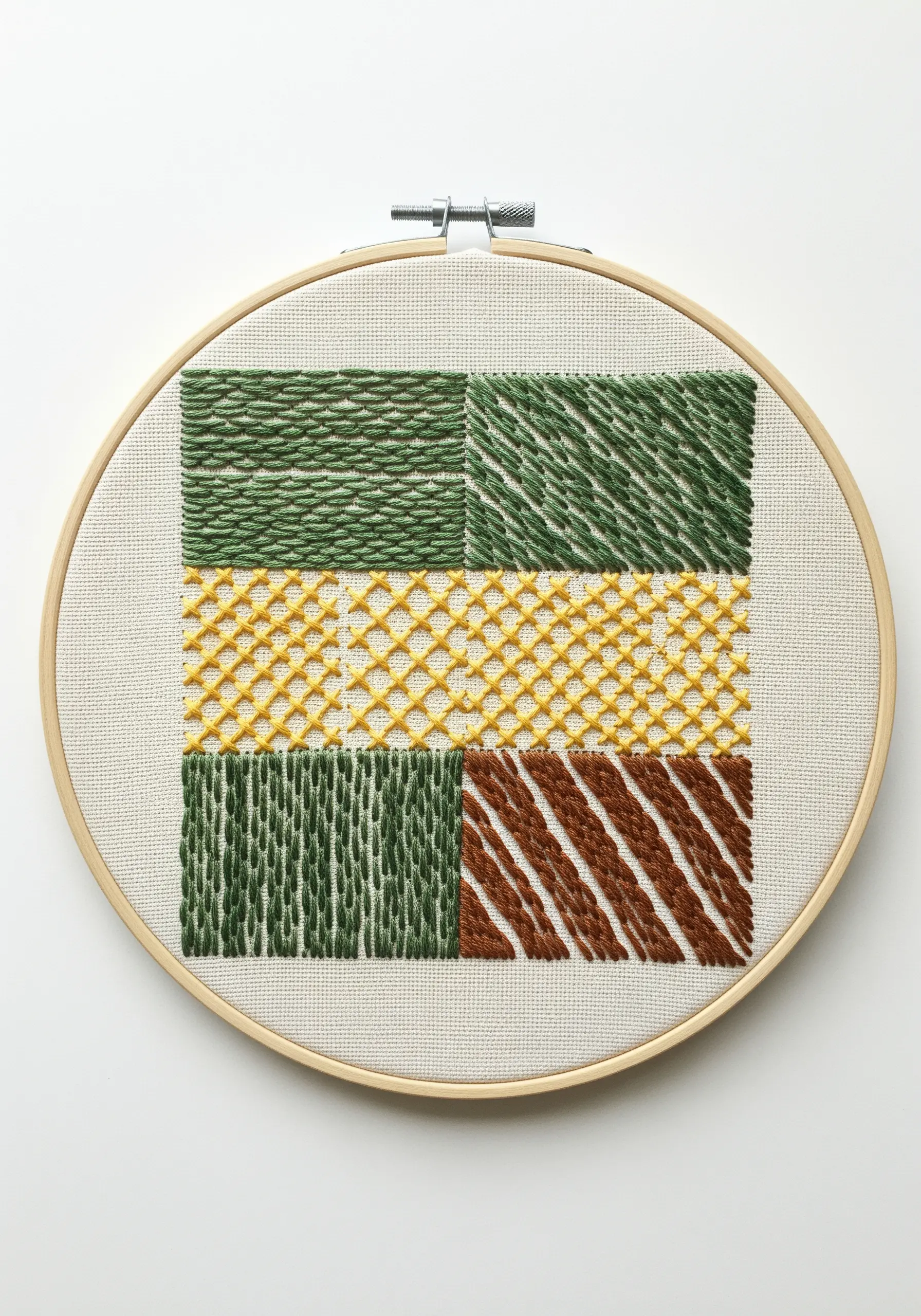 An embroidery sampler showcasing four different filling stitches in green, yellow, and brown.