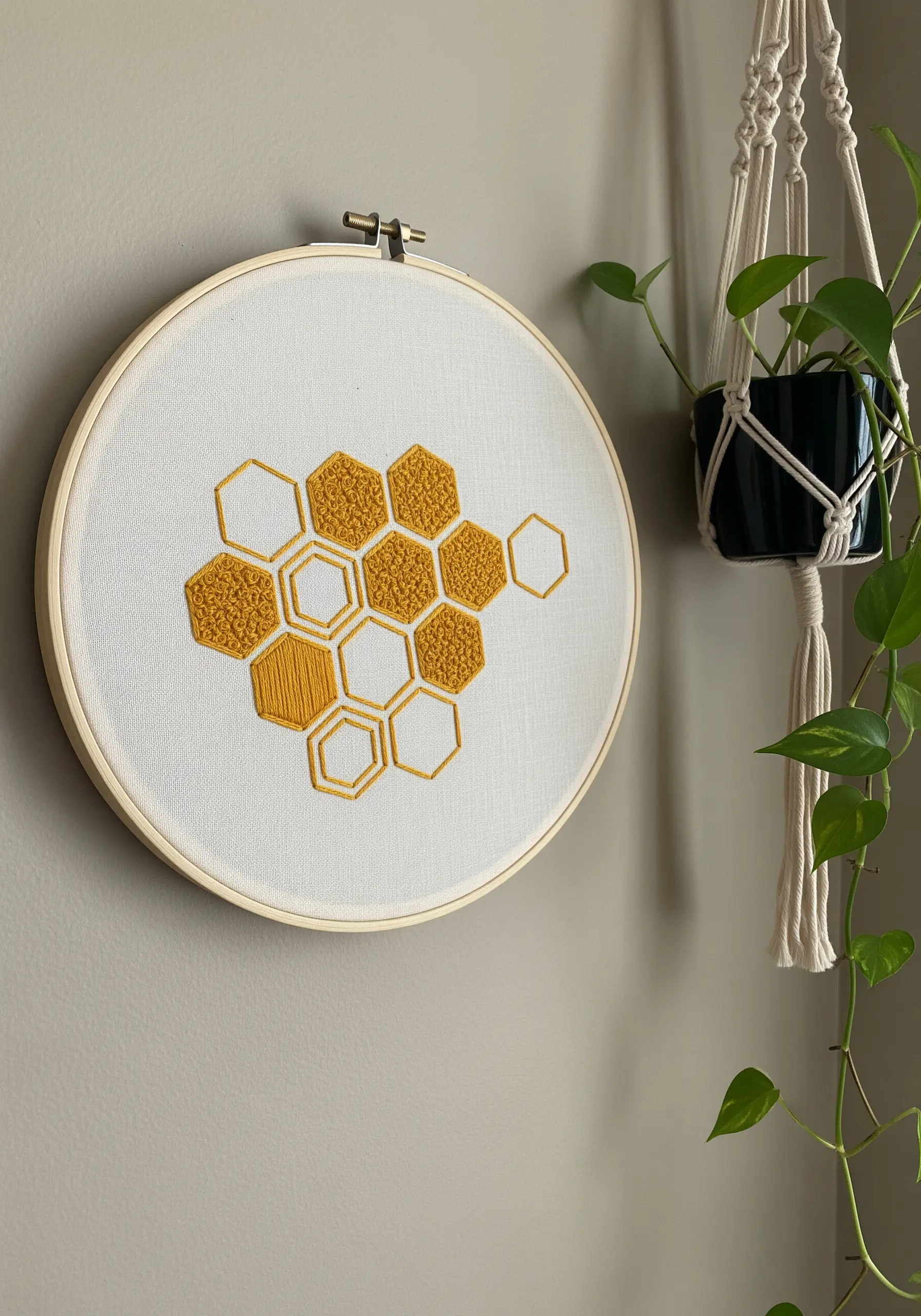 Modern embroidery of a honeycomb, with some cells filled with texture.