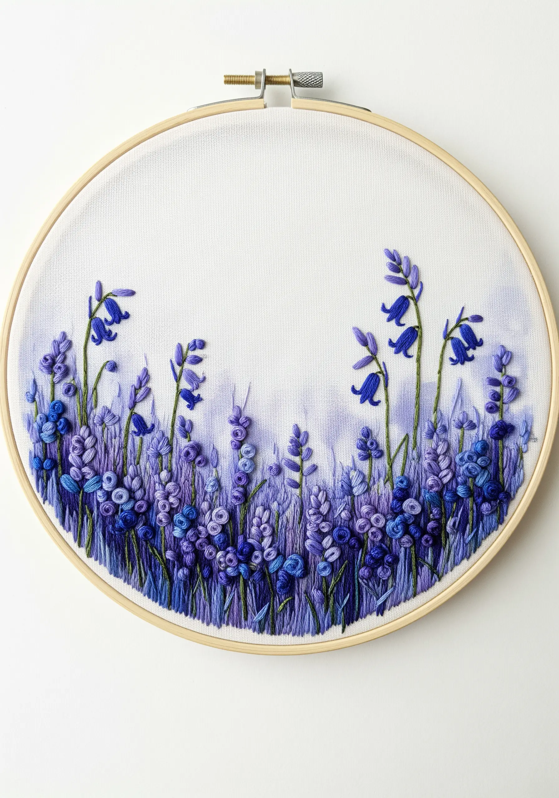 A field of bluebell flowers that becomes less detailed toward the top to create depth.