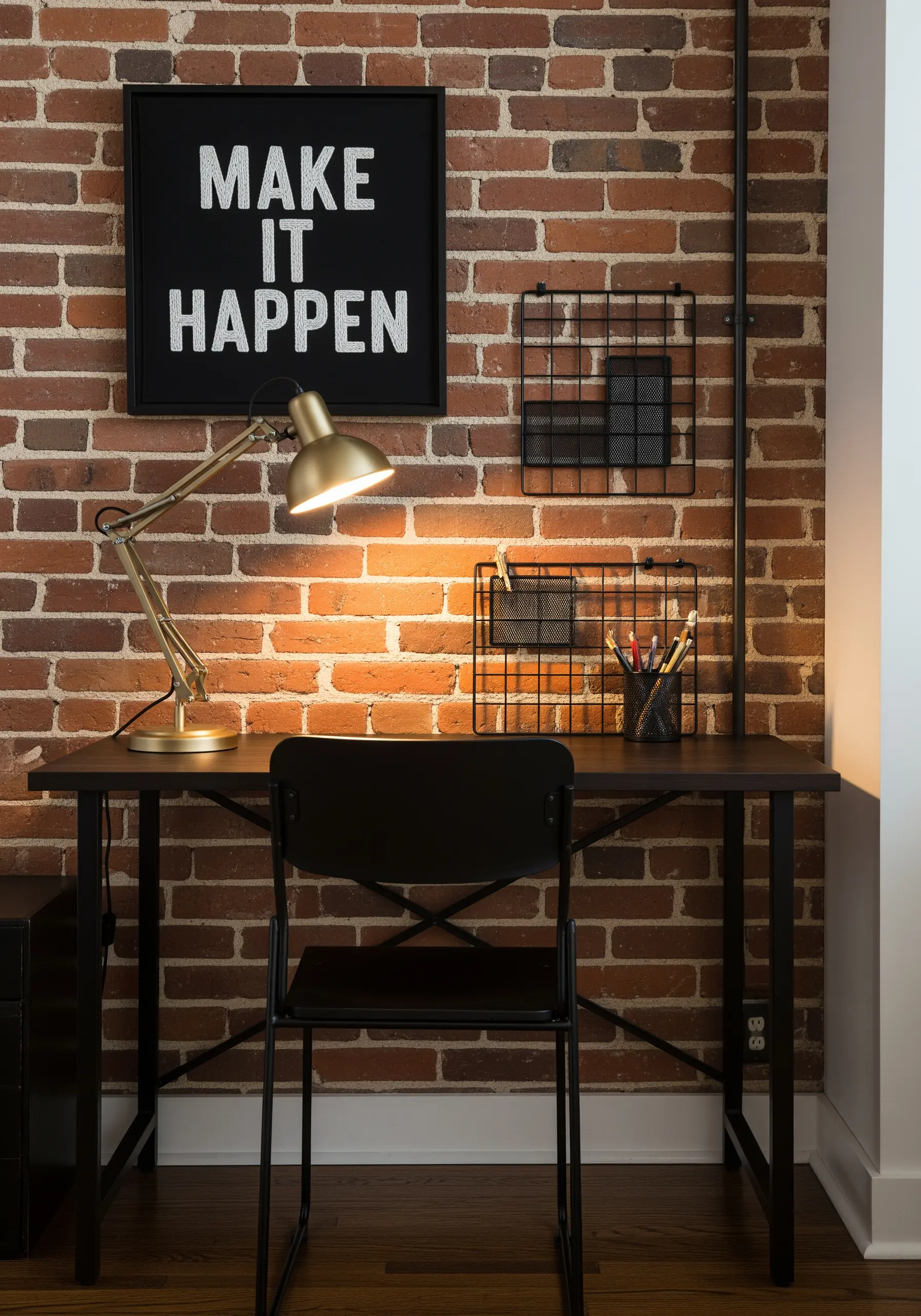 Bold white chain-stitched quote 'Make It Happen' on black fabric in a black frame.