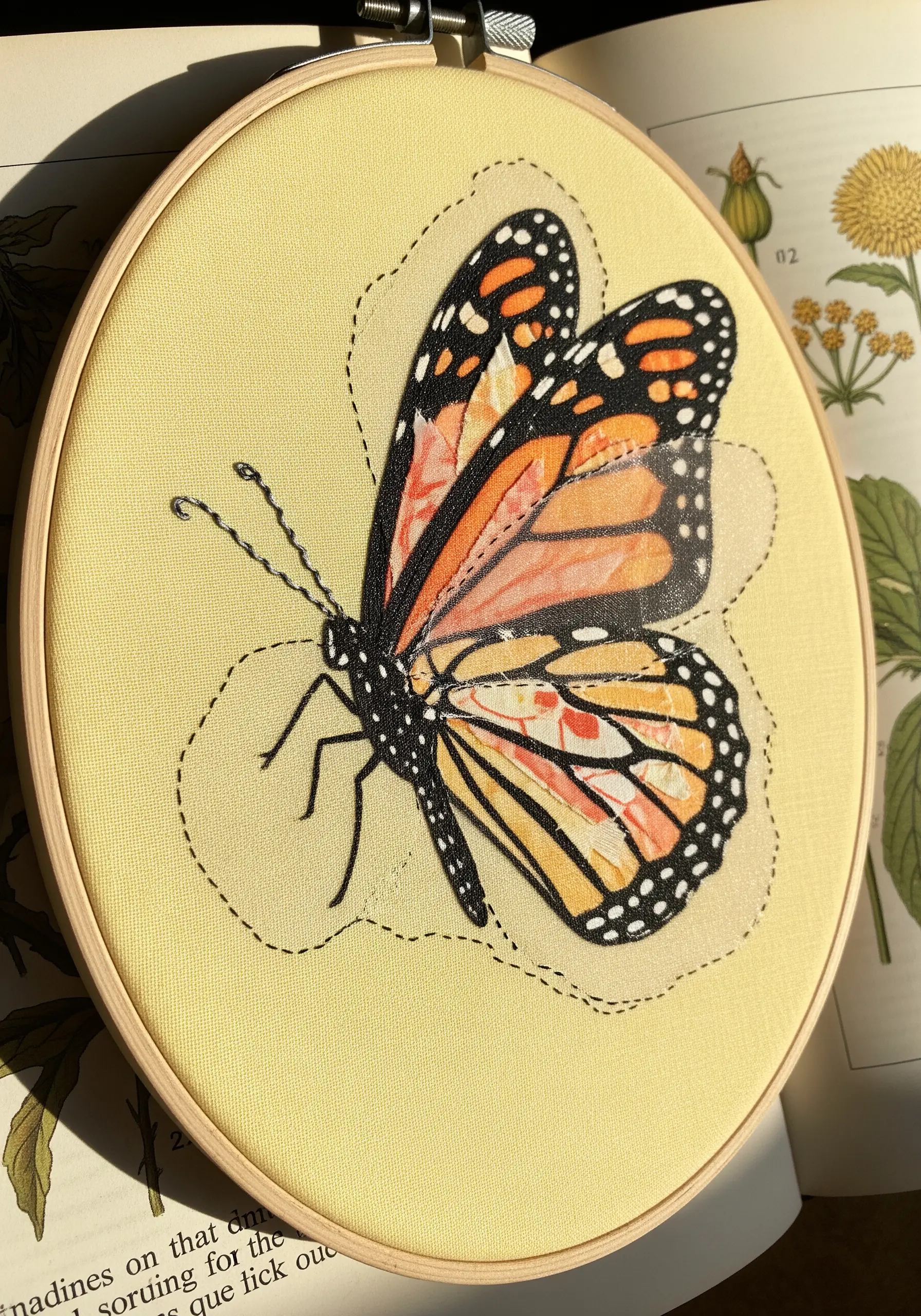 Embroidered monarch butterfly with a sheer organza layer over its wings for a delicate effect.