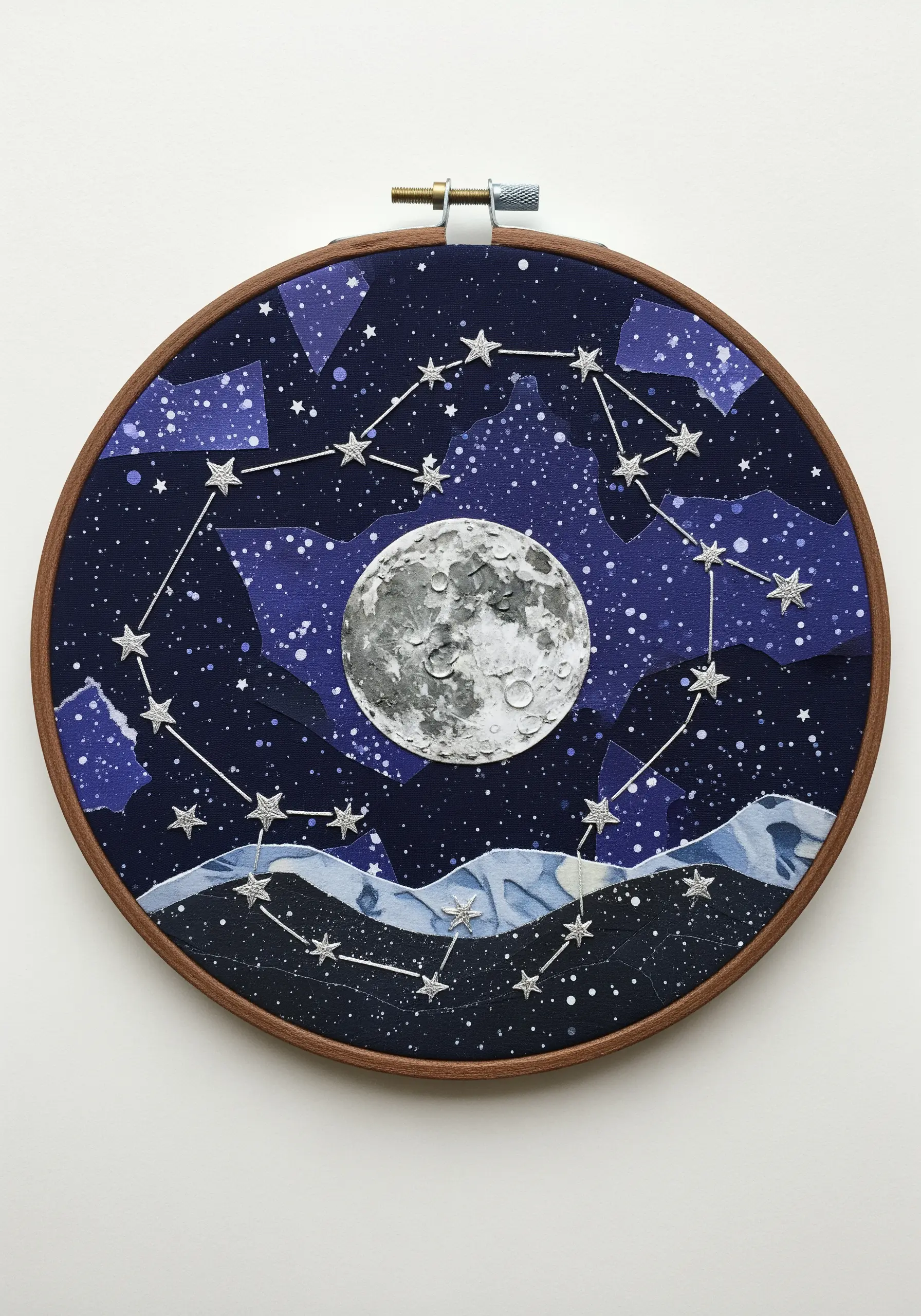 A celestial embroidery hoop with a collaged fabric night sky and stitched constellations.