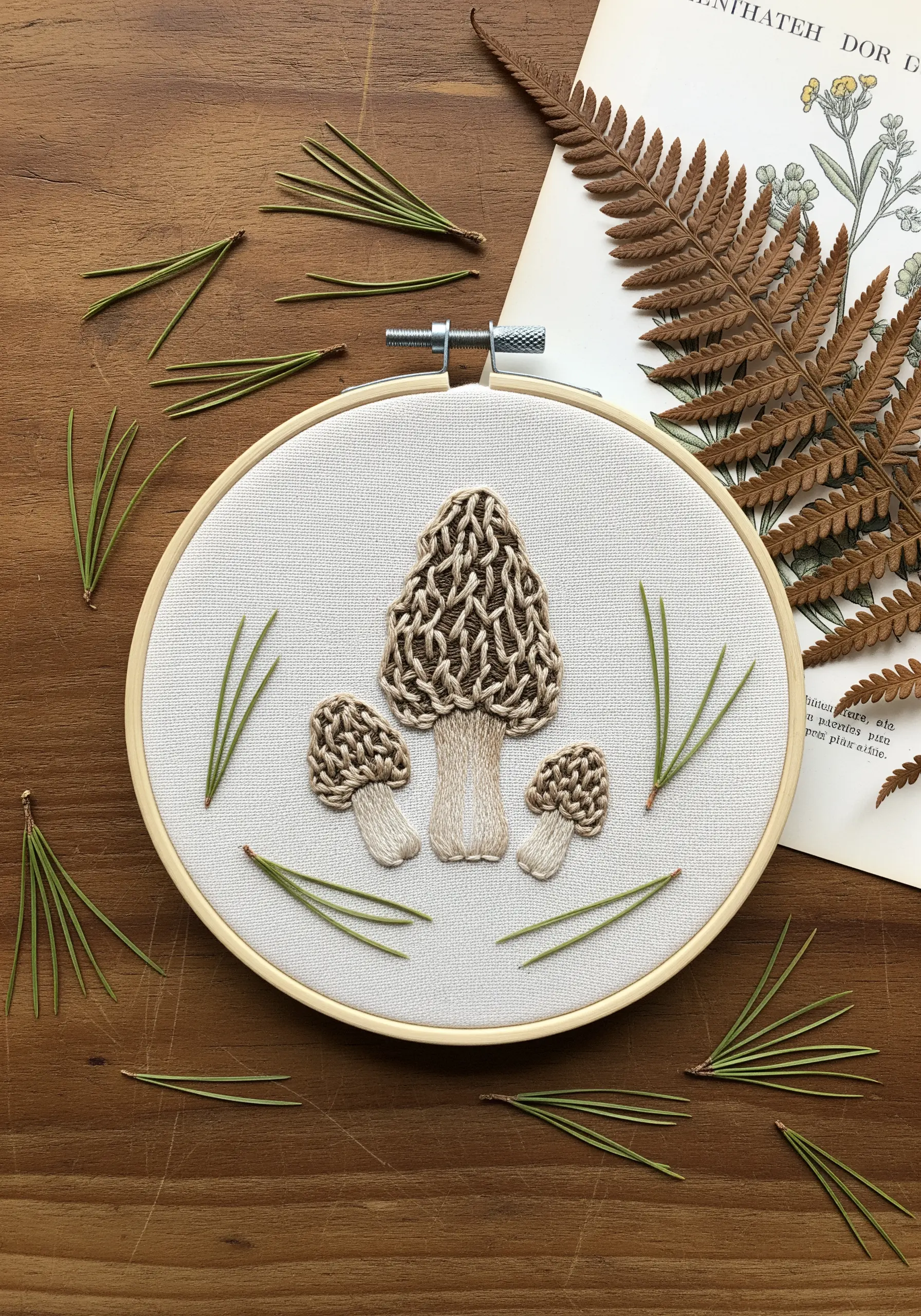 Embroidered morel mushrooms with intricate stem stitch texture on cream fabric.