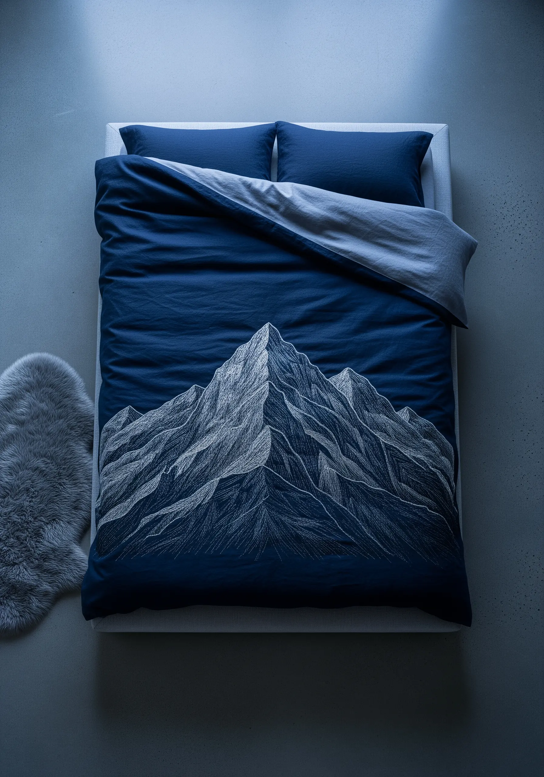 Embroidered mountain range in white and grey on a deep navy blue duvet cover