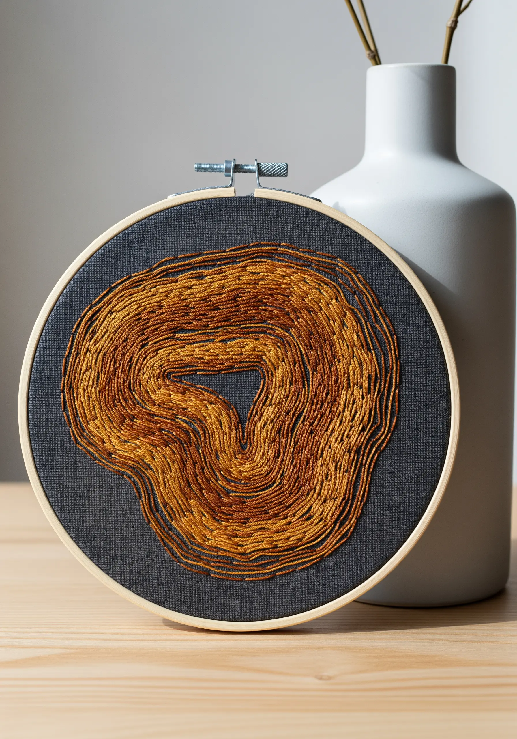 Abstract wood grain pattern with flowing stitches in shades of brown and gold.