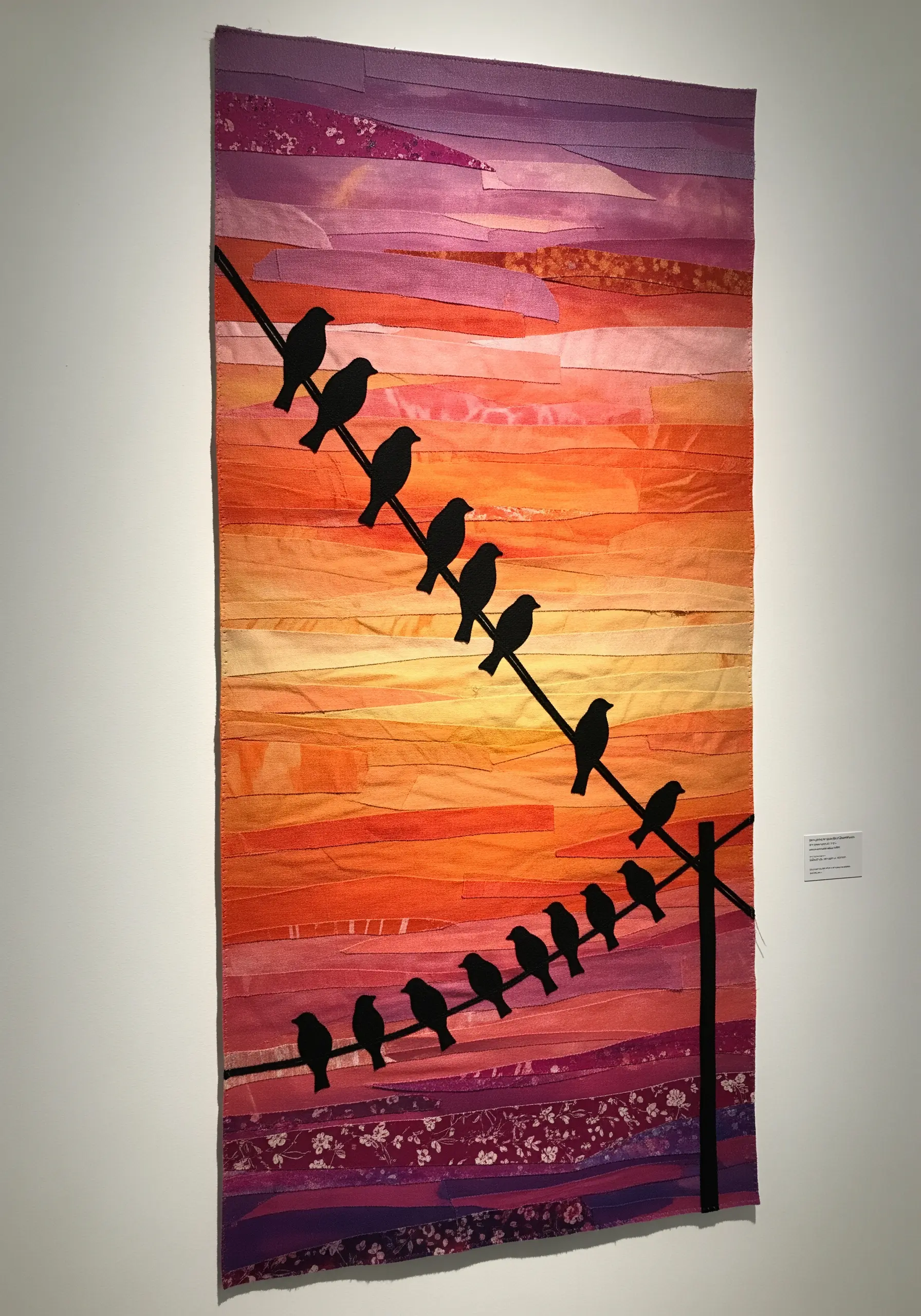 Wall hanging with a sunset background made of horizontally stitched fabric strips
