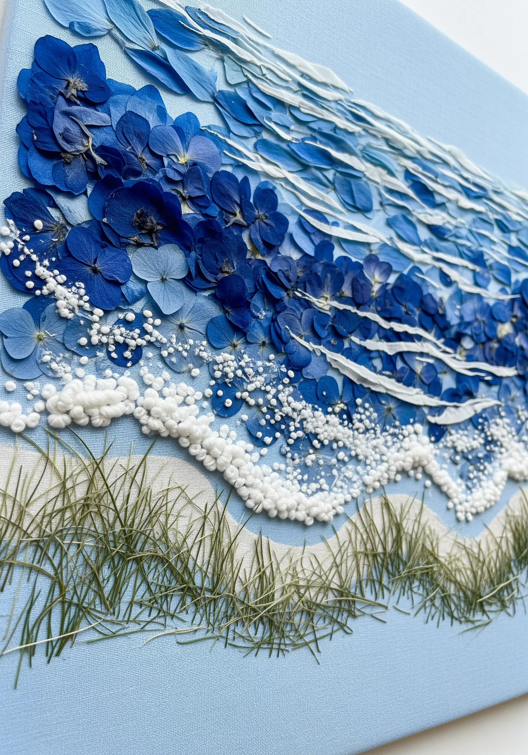 An abstract ocean wave created from layered blue hydrangea petals and white flowers.