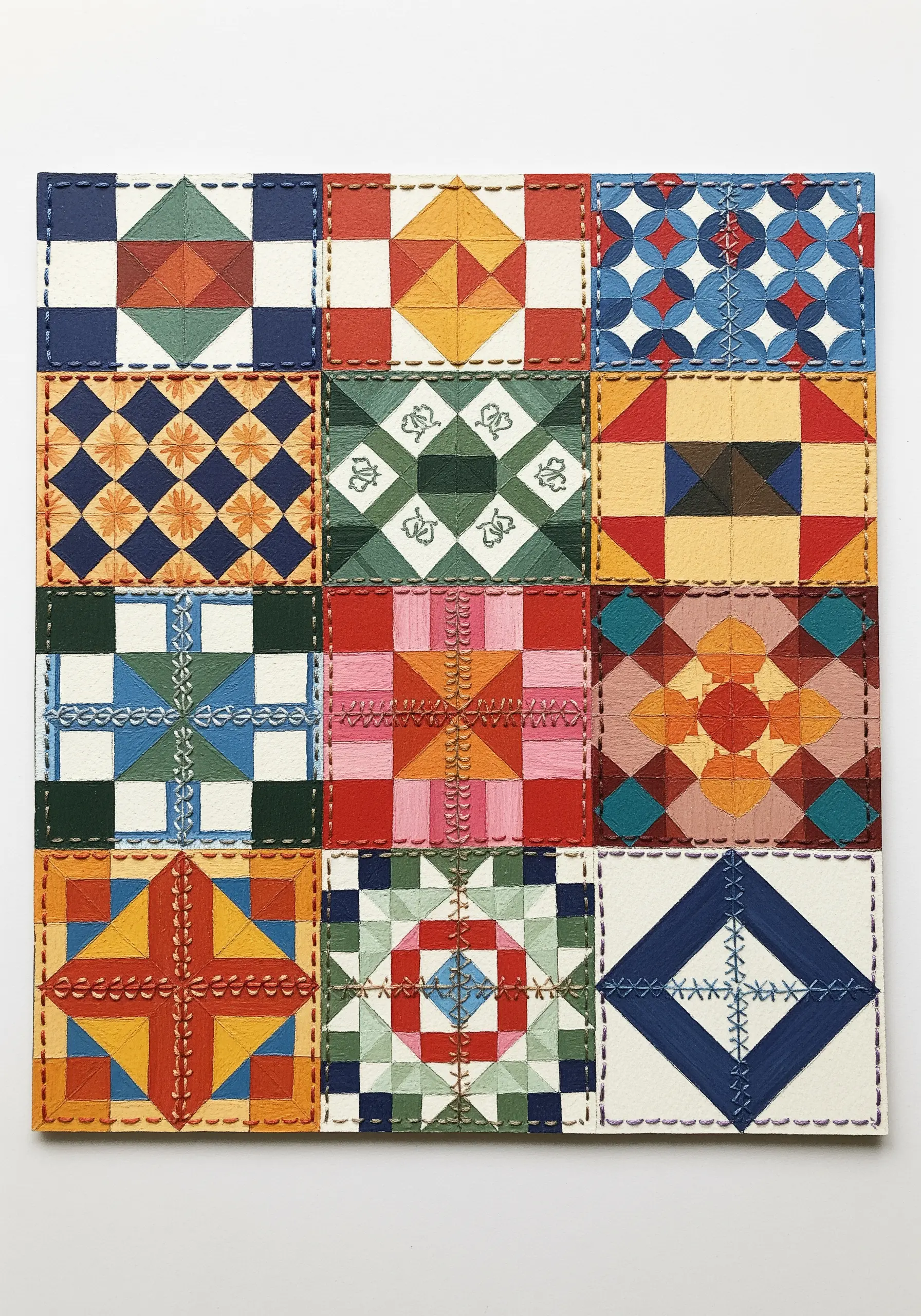 Painted quilt block patterns on a panel with decorative hand-stitching along the seams.
