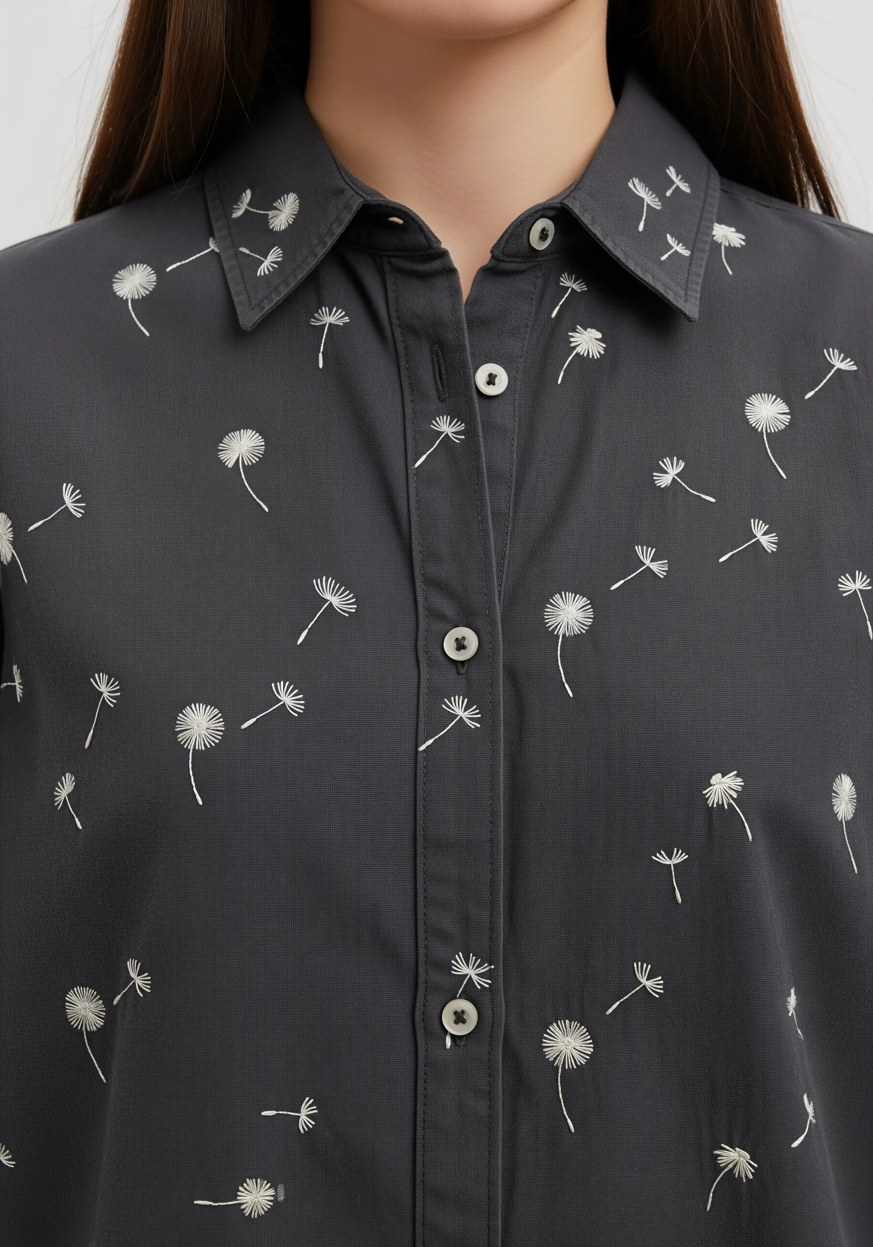 A dark gray button-down shirt with a scattered, all-over pattern of embroidered dandelion seeds.
