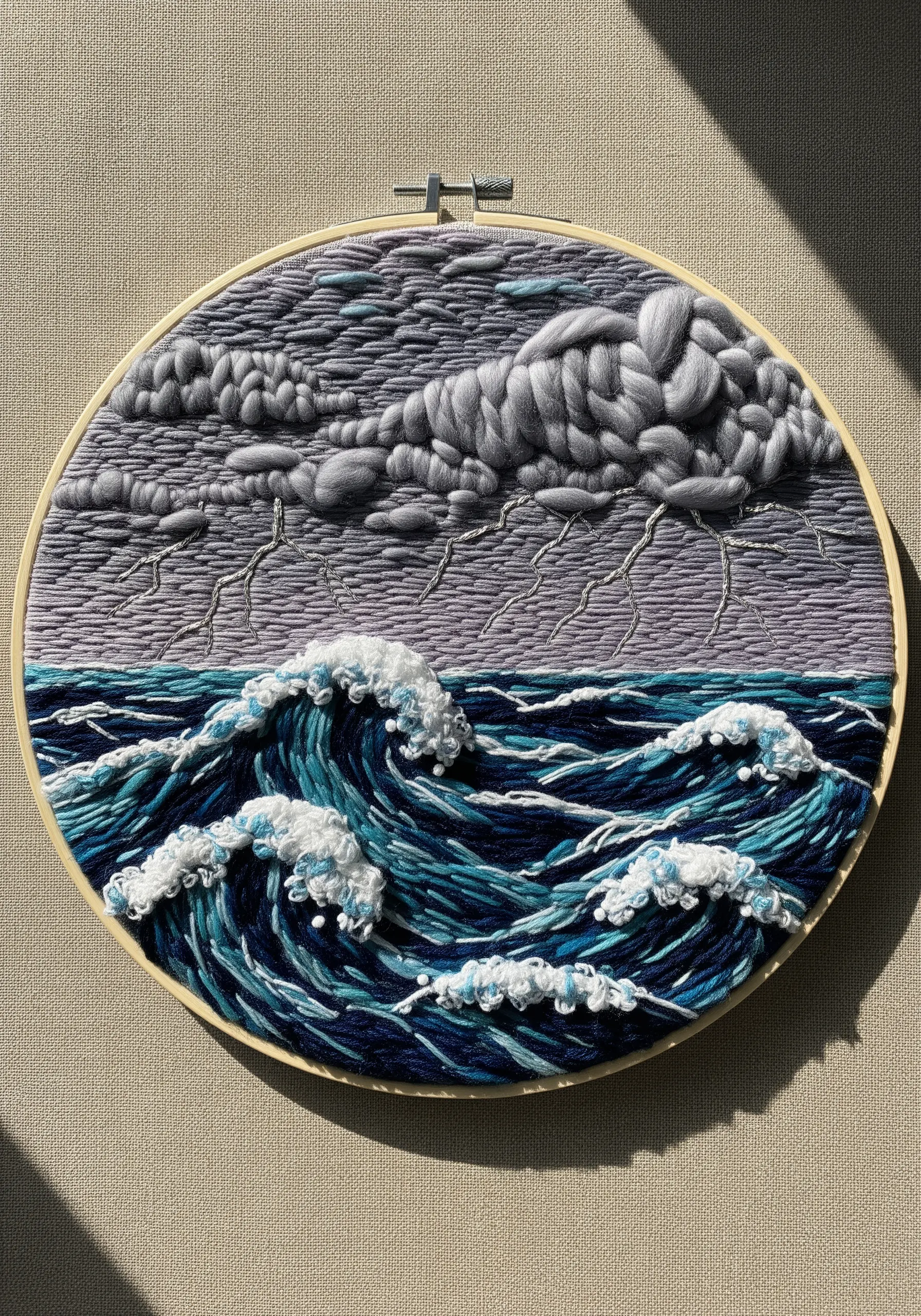 Embroidered stormy sea with thick yarn clouds, French knot sea foam, and lightning stitches.