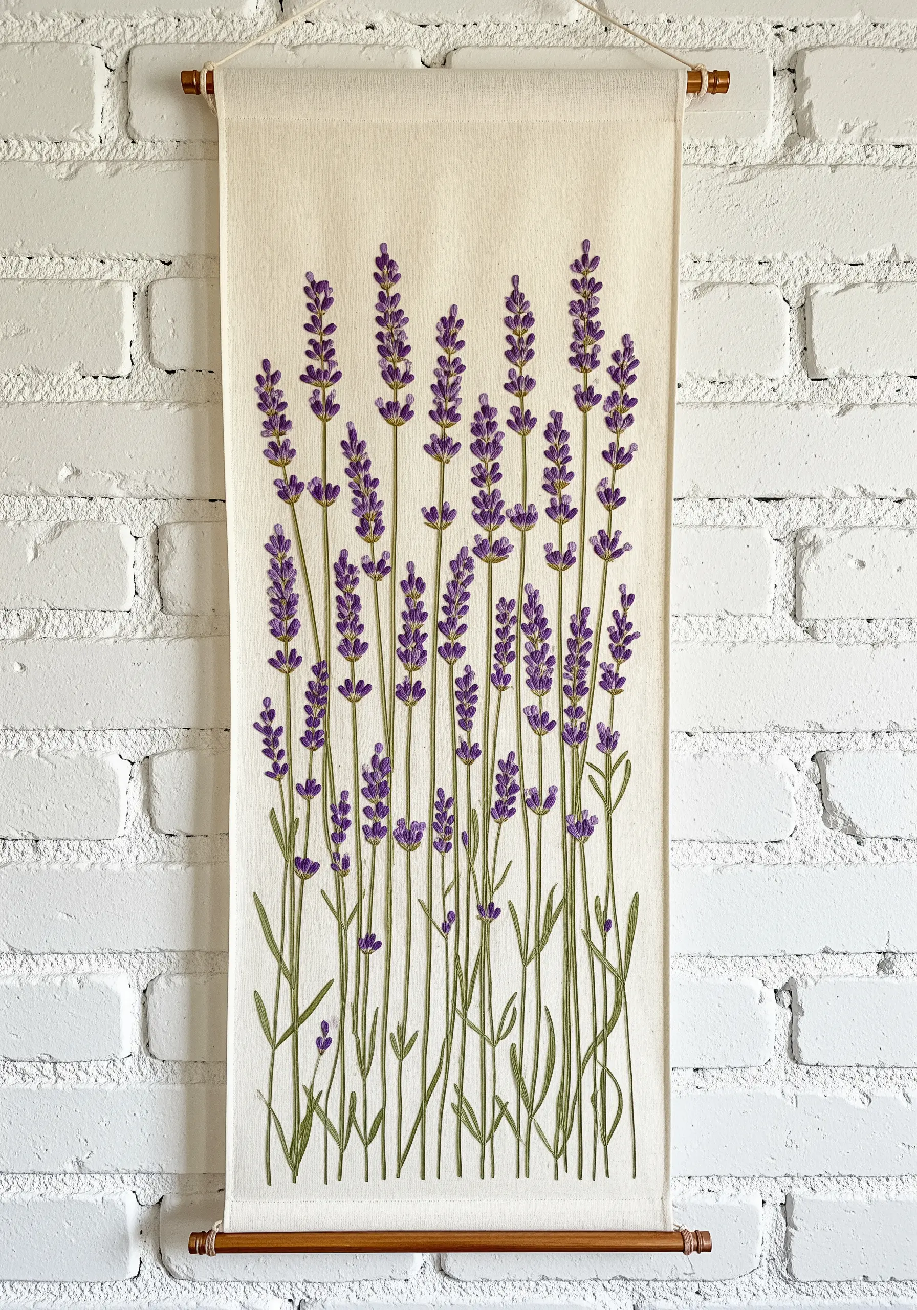 A wall hanging with rows of embroidered lavender stalks on a neutral canvas.