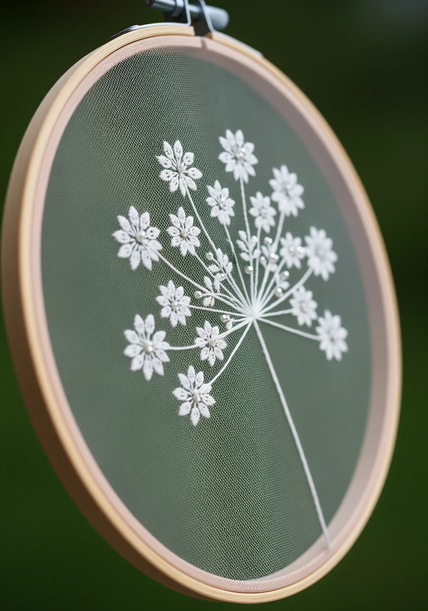 Embroidered Queen Anne's lace on sheer fabric, using lazy daisy stitches and French knots.