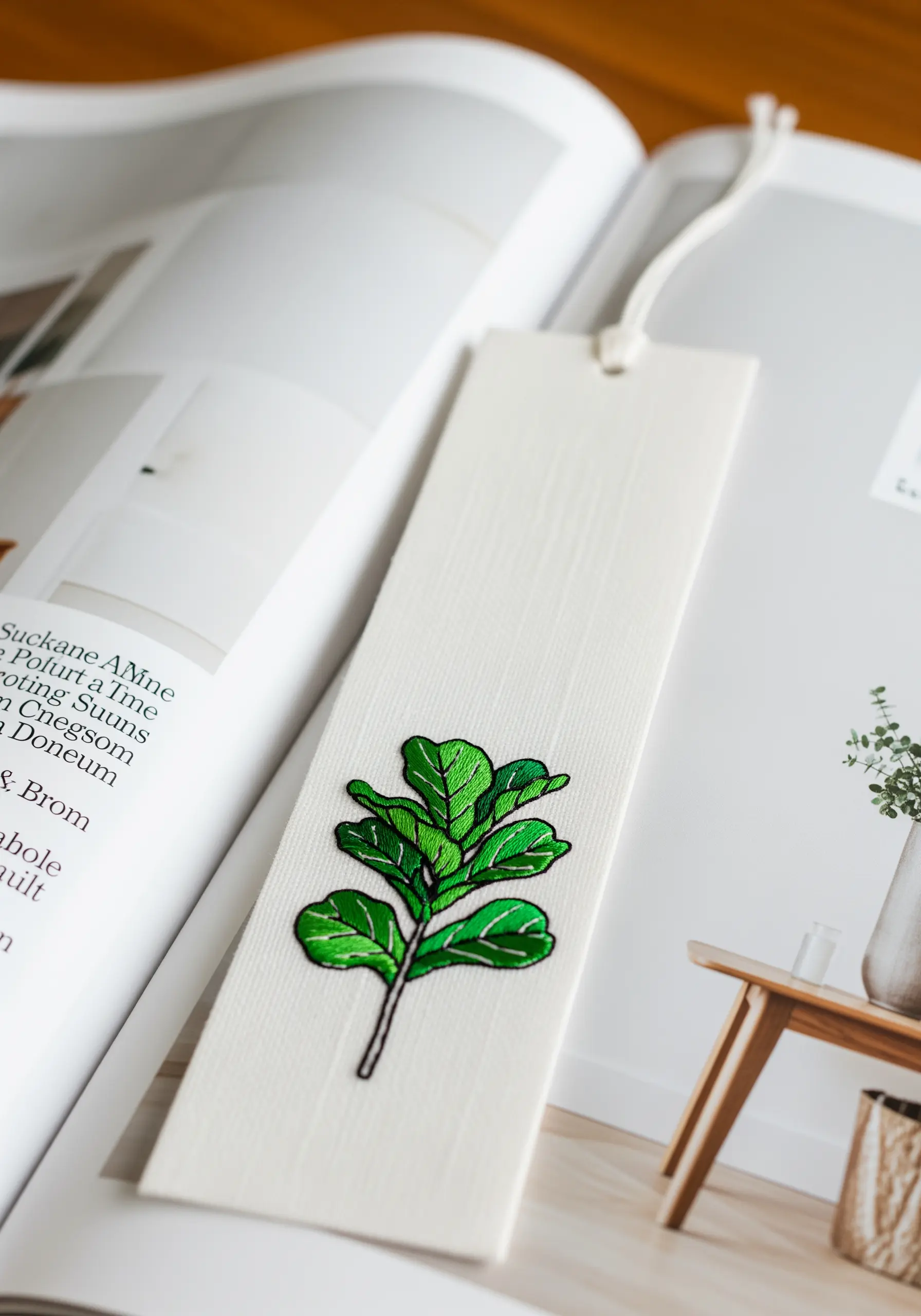 An embroidered patch of a fiddle-leaf fig branch with a bold black outline.