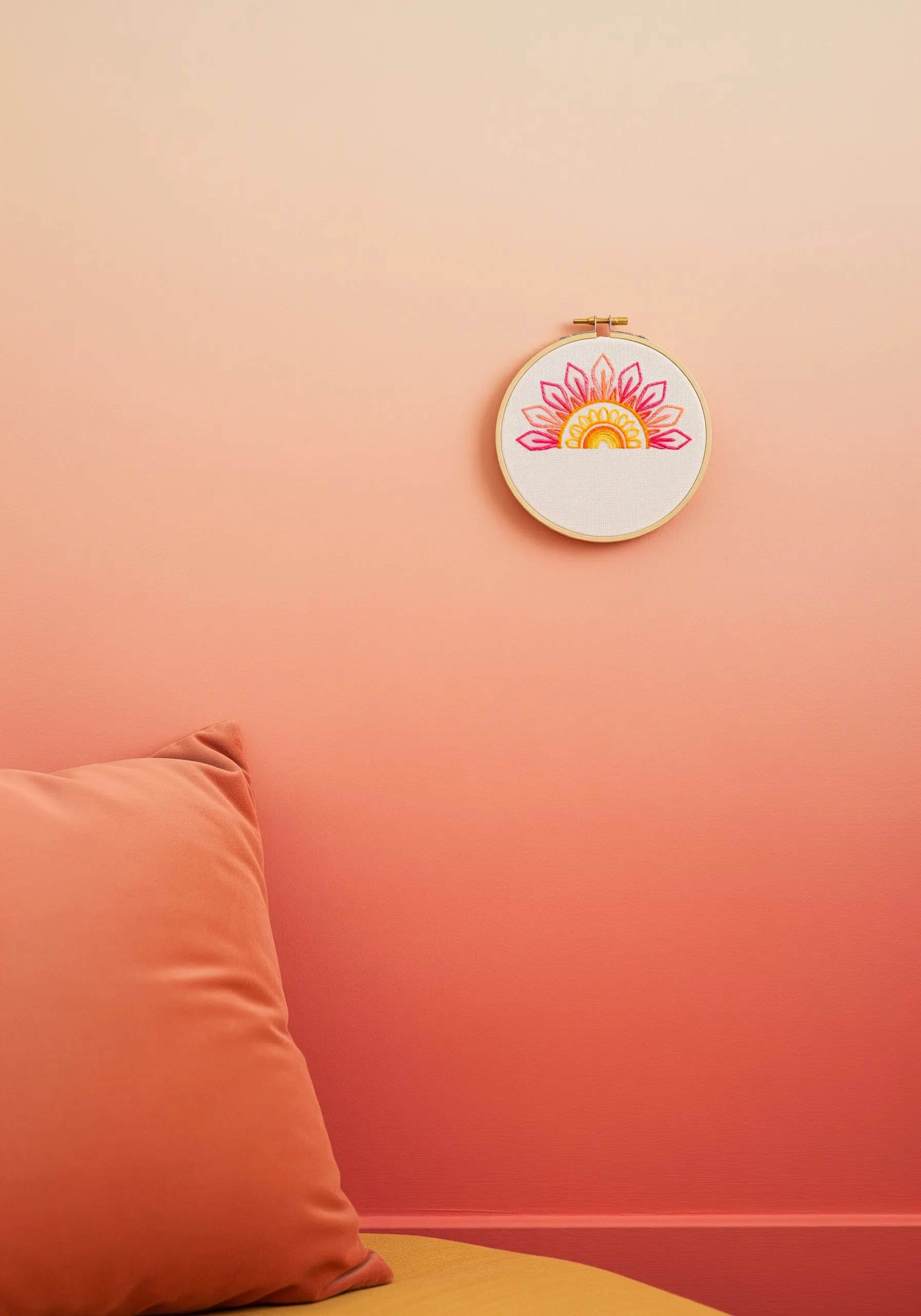 A half-mandala in sunset colors of pink, orange, and yellow.