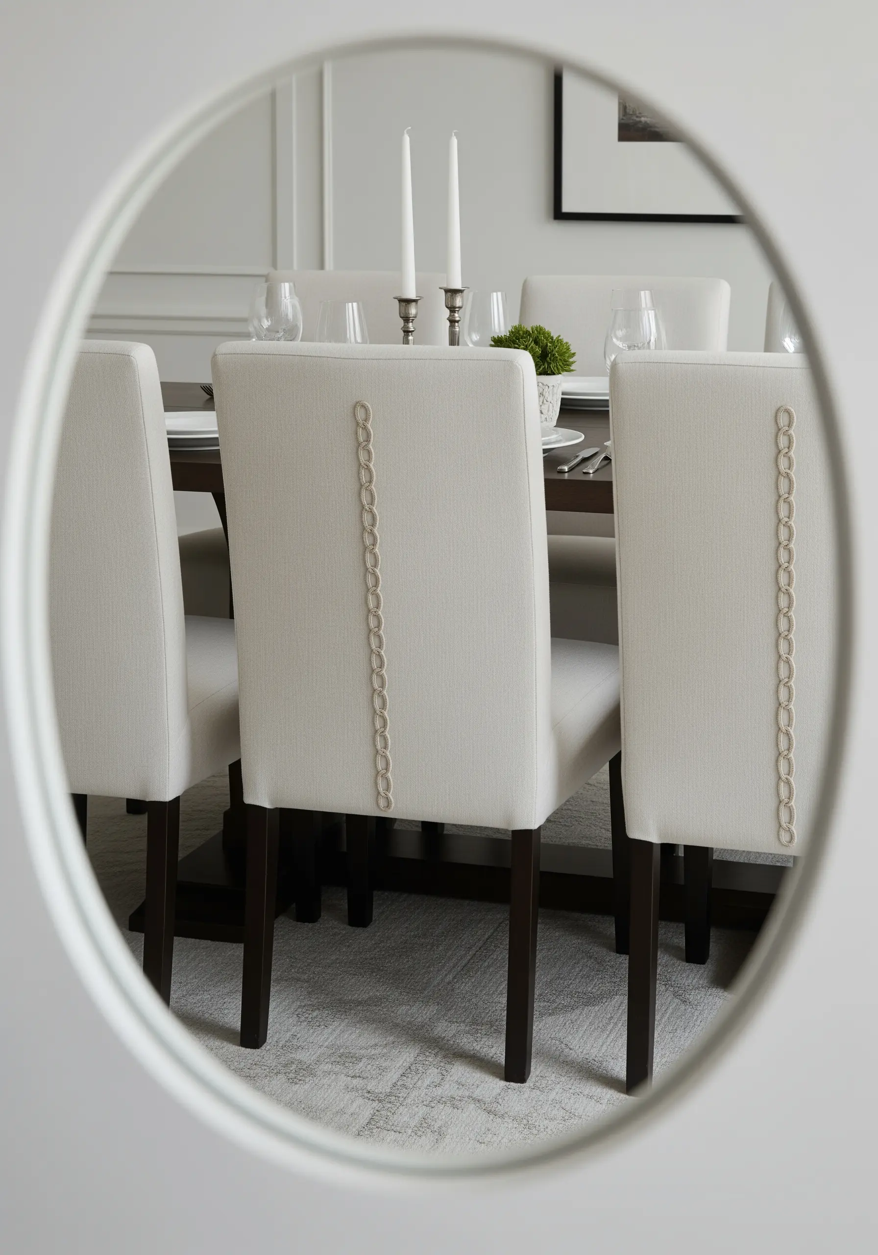 Tone-on-tone embroidered chain link pattern running vertically down the back of a dining chair.