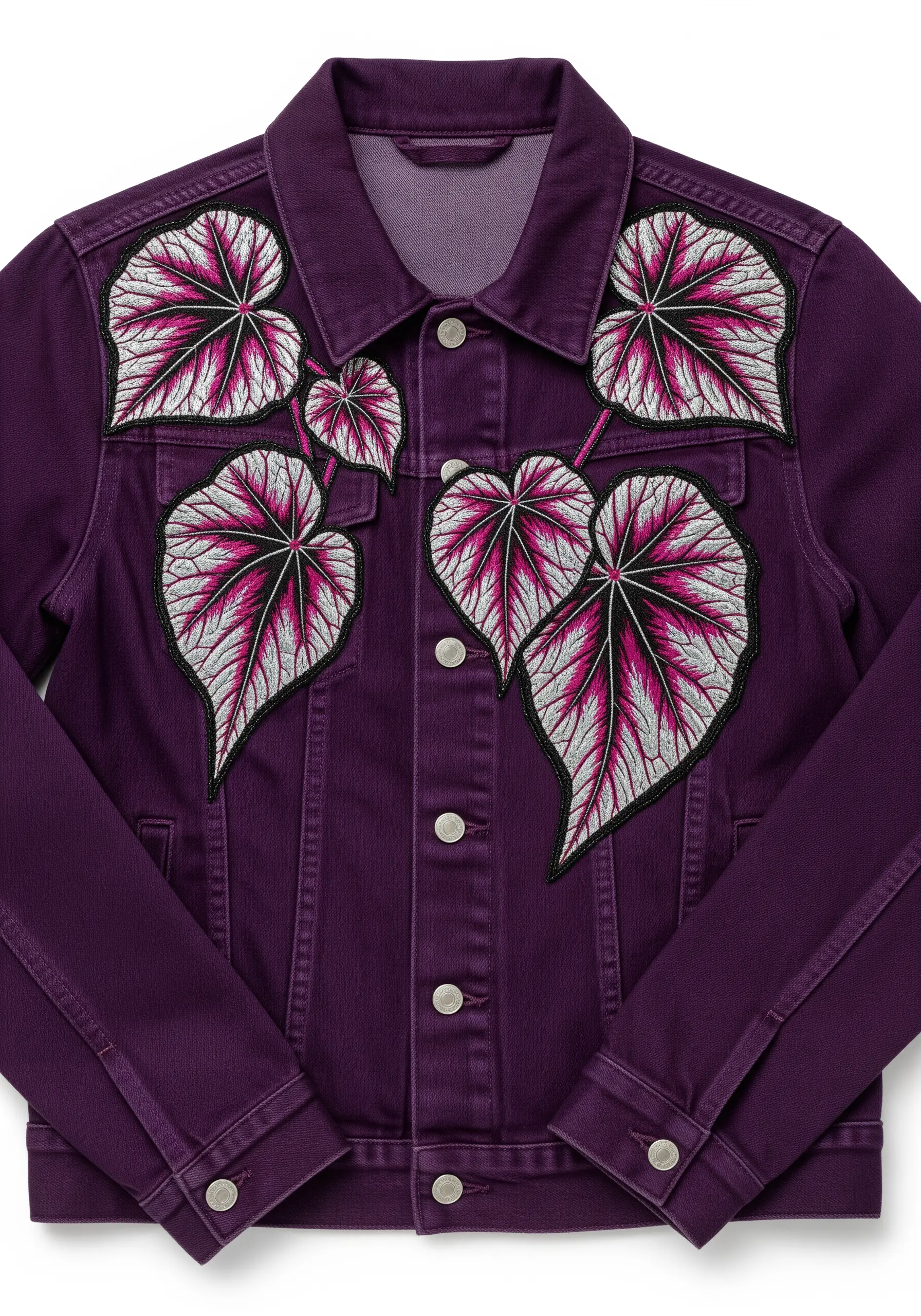 Begonia leaves embroidered in fuchsia, silver, and black on a purple denim jacket.