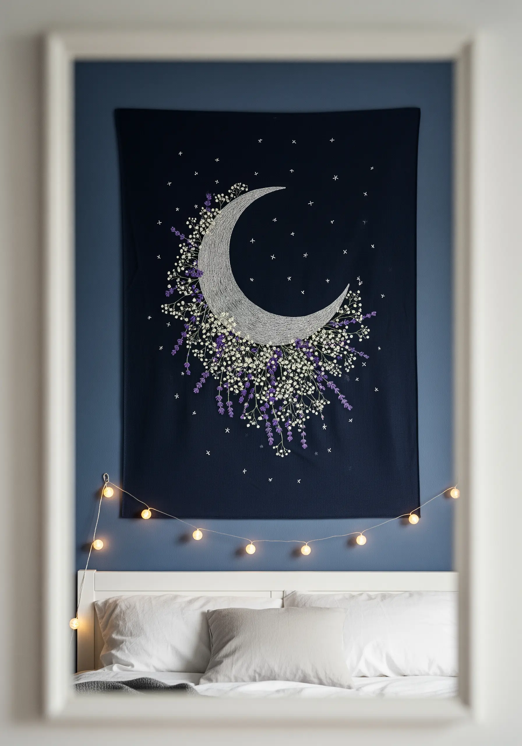 A dark blue wall tapestry with an embroidered crescent moon surrounded by lavender and stars.