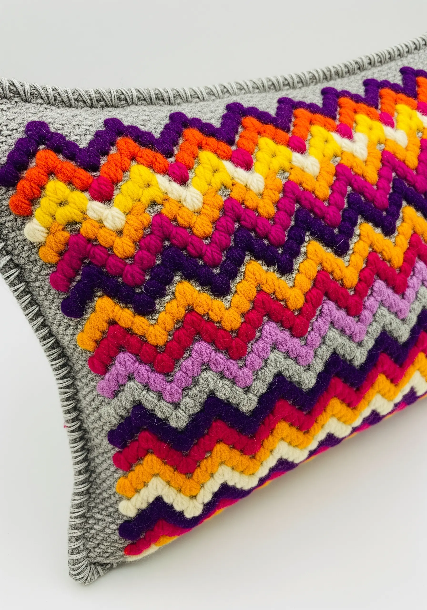 A vibrant chevron pattern in Bargello needlepoint using thick, colorful yarn