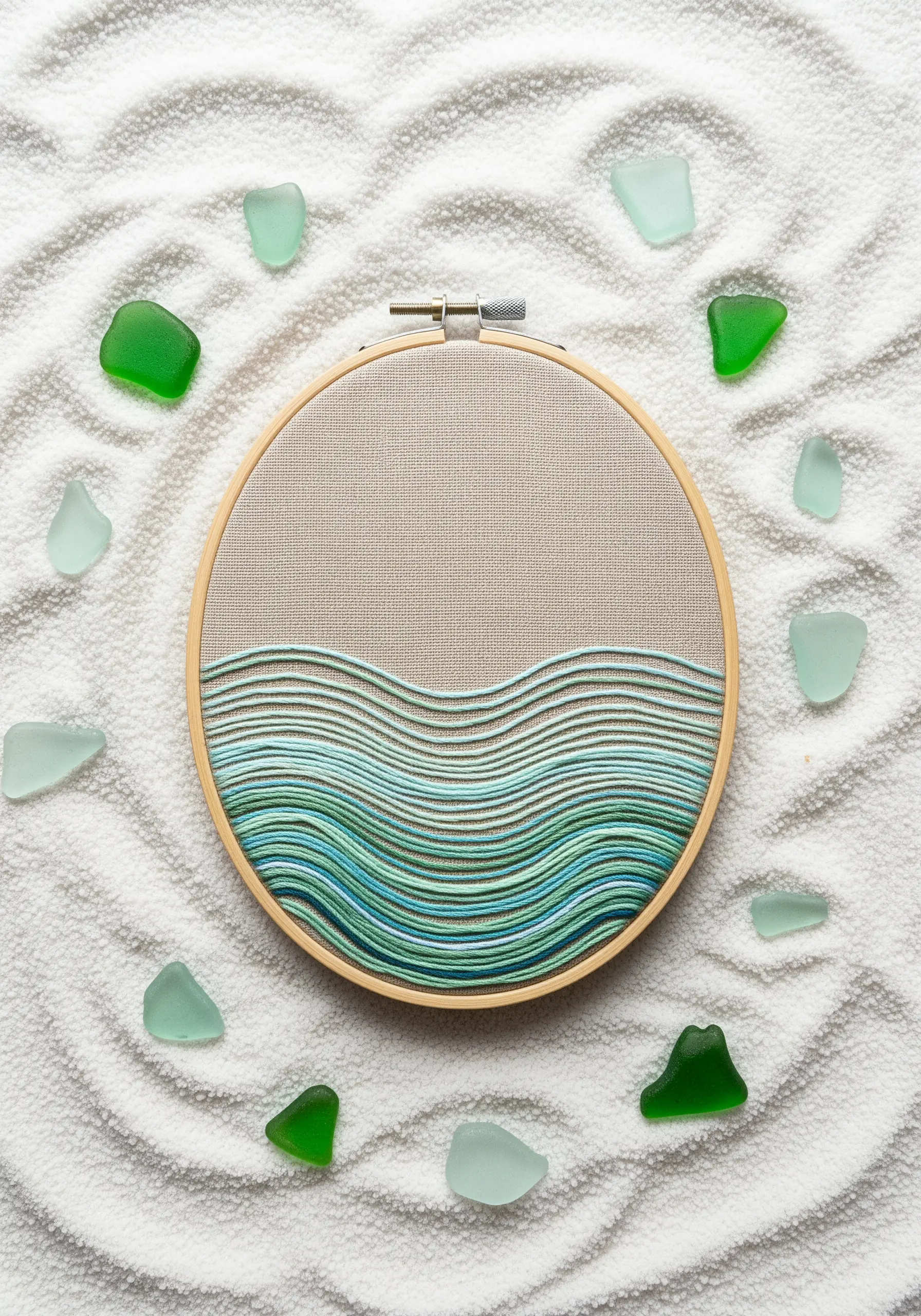 Minimalist embroidery of ocean waves made with parallel running stitches in shades of blue and green.