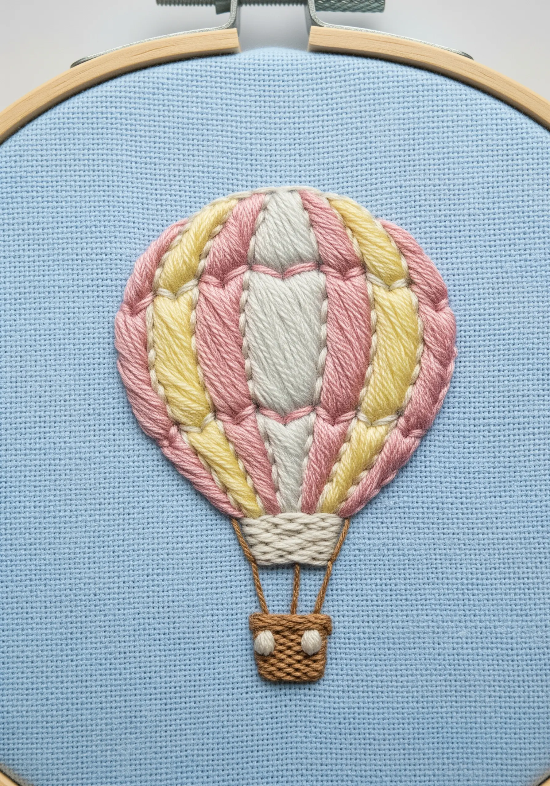 A colorful hot air balloon with padded satin stitch panels in pink and yellow.