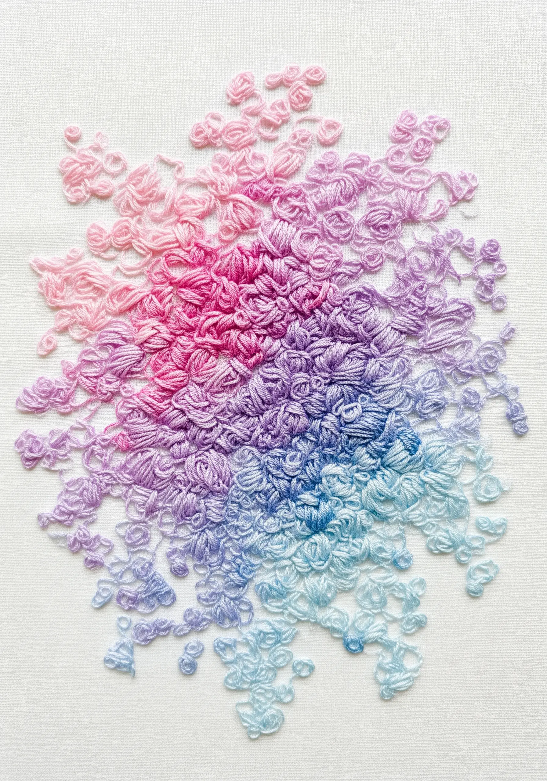 An abstract embroidery with a gradient of pink, purple, and blue knotted loop stitches.