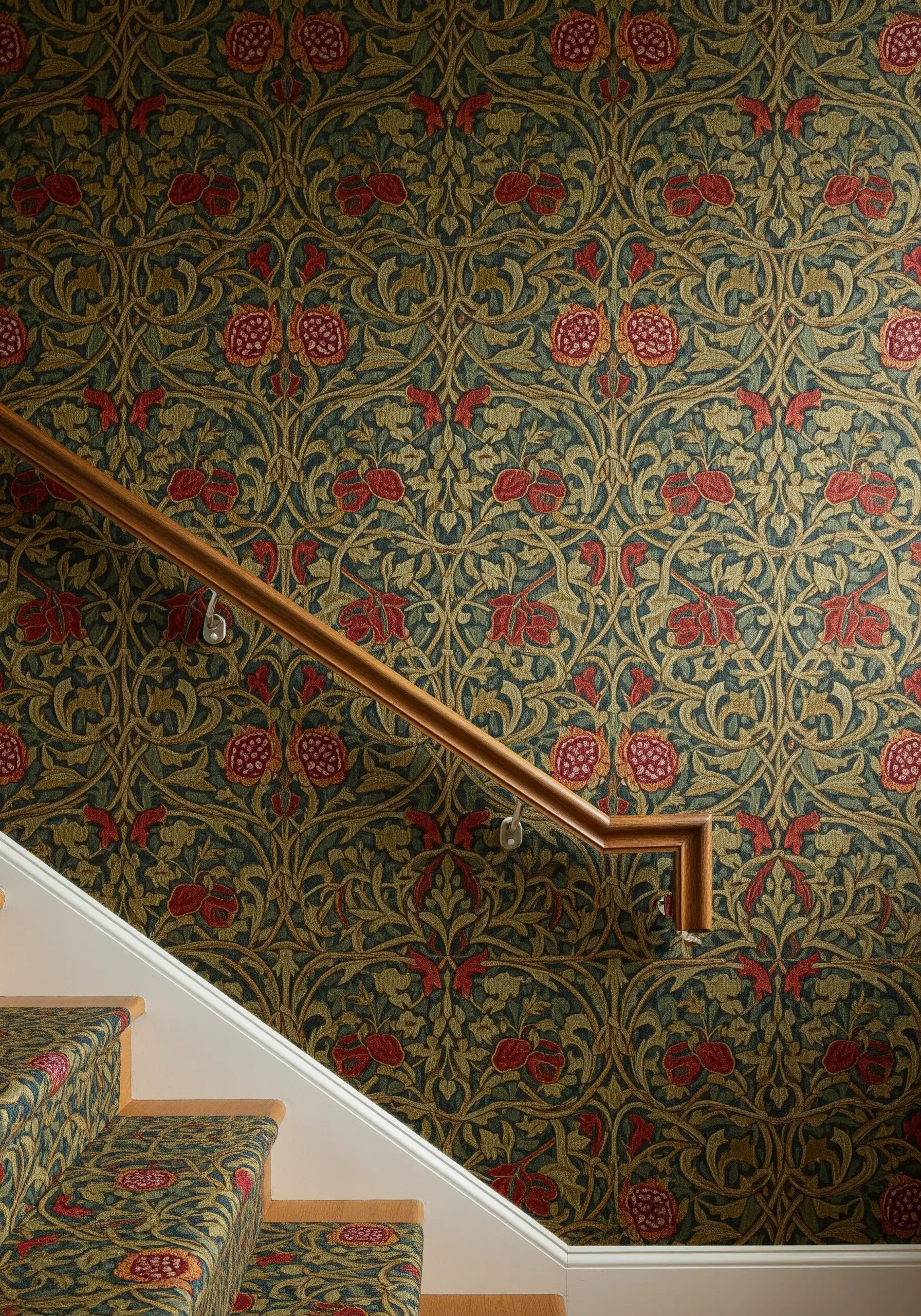 A staircase with walls and steps covered in a dense, repeating floral pattern in the William Morris style.