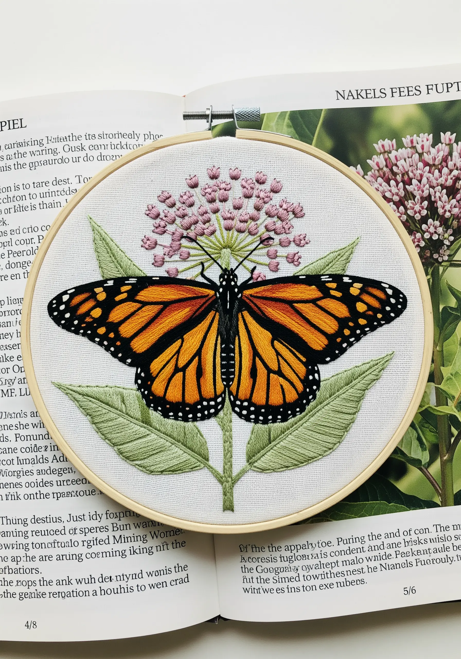 A detailed monarch butterfly, thread-painted with sharp black outlines, on a milkweed plant.