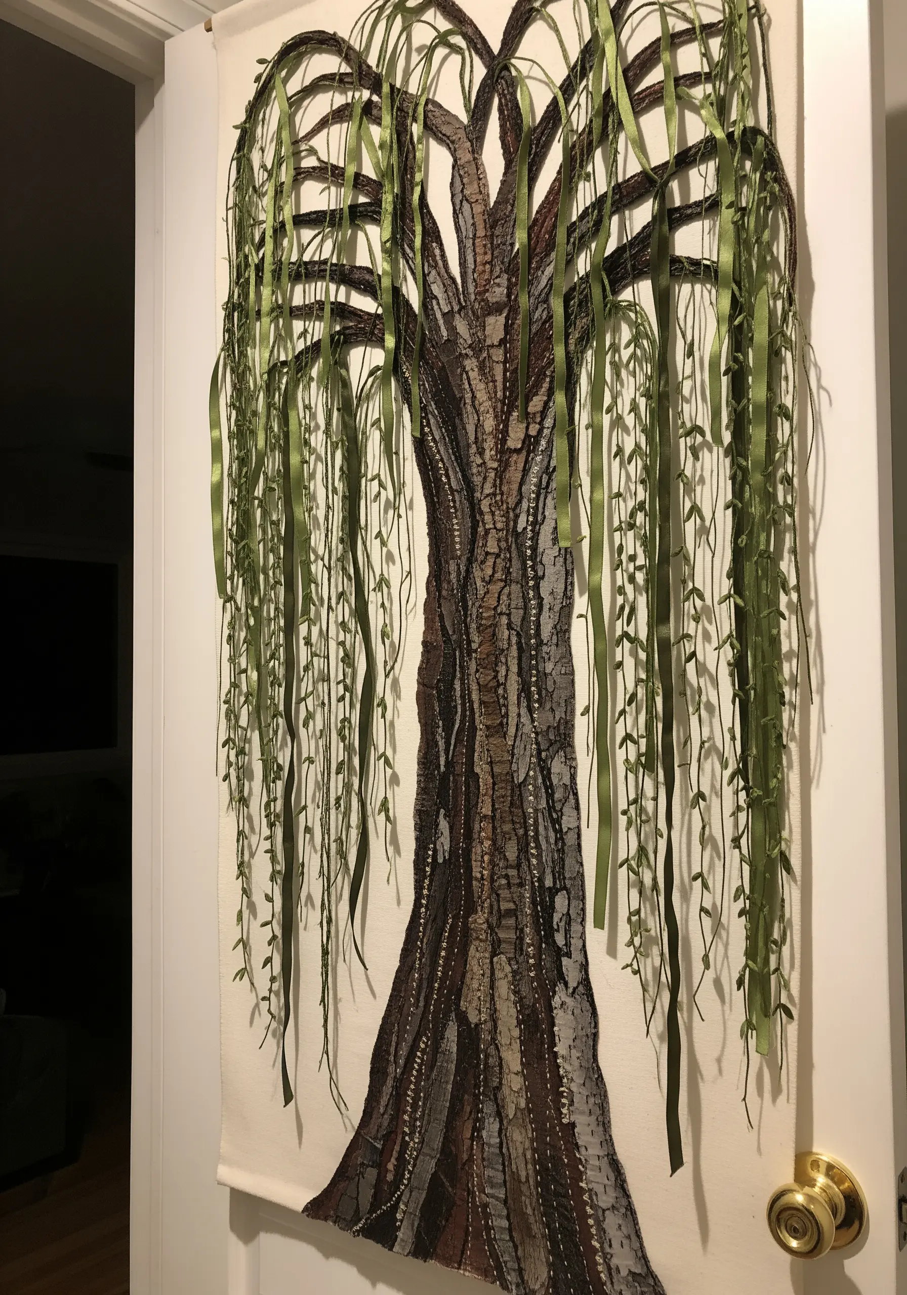 Large fabric collage wall hanging of a weeping willow with hanging ribbons.
