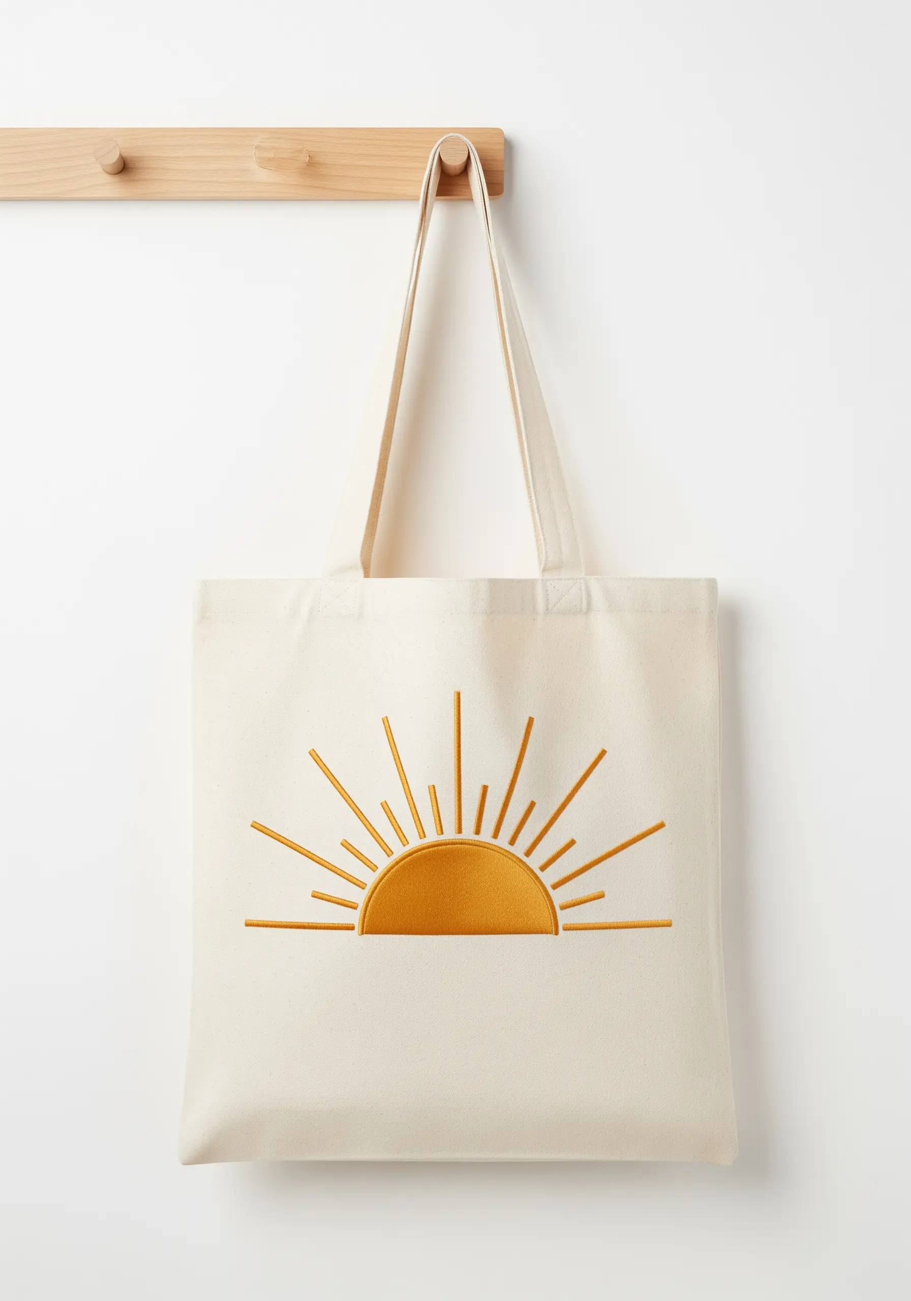 A stylized golden sunburst with a satin-stitched semi-circle and straight-stitch rays.
