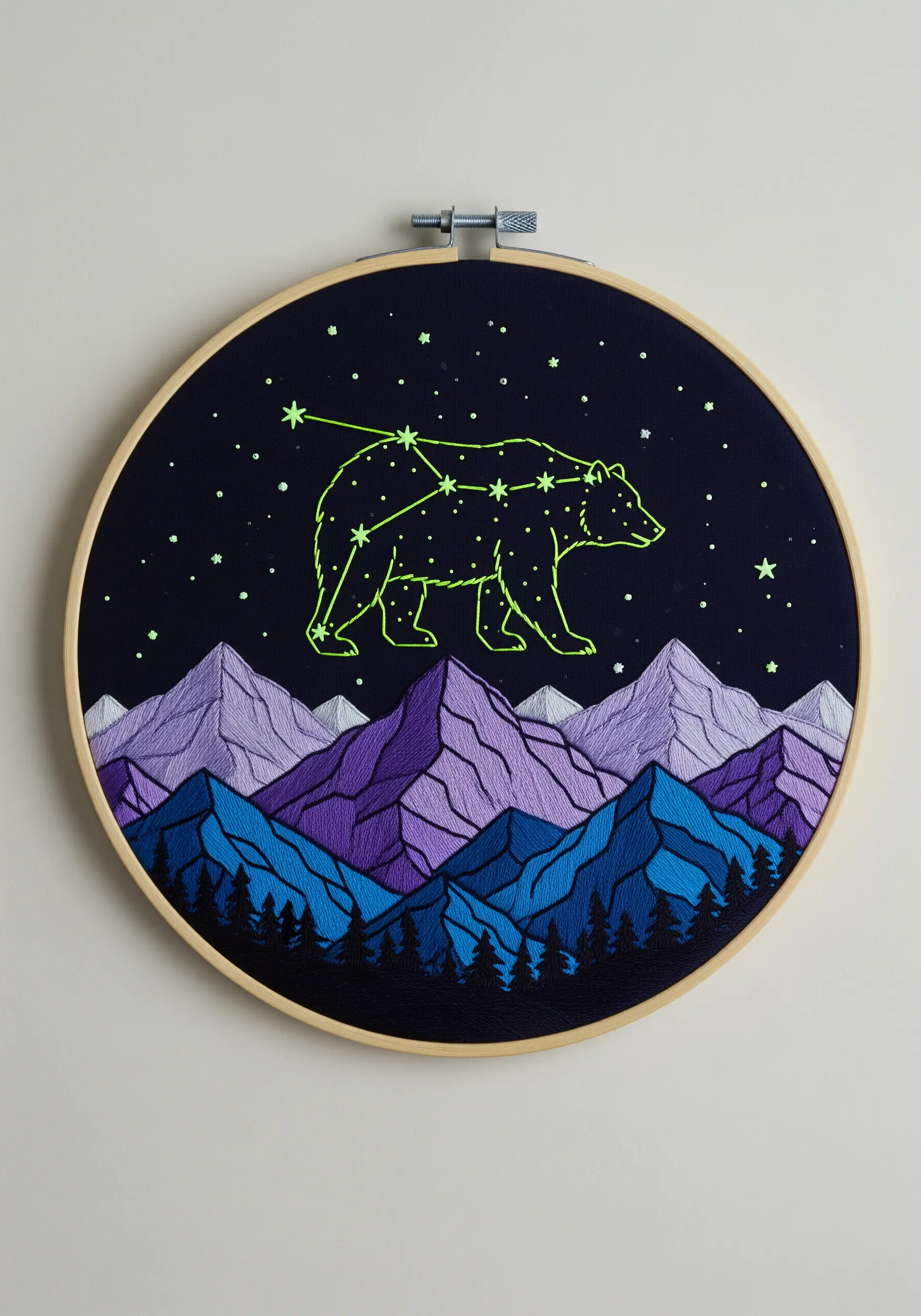 Embroidered mountains with a bear constellation stitched in glow-in-the-dark thread.