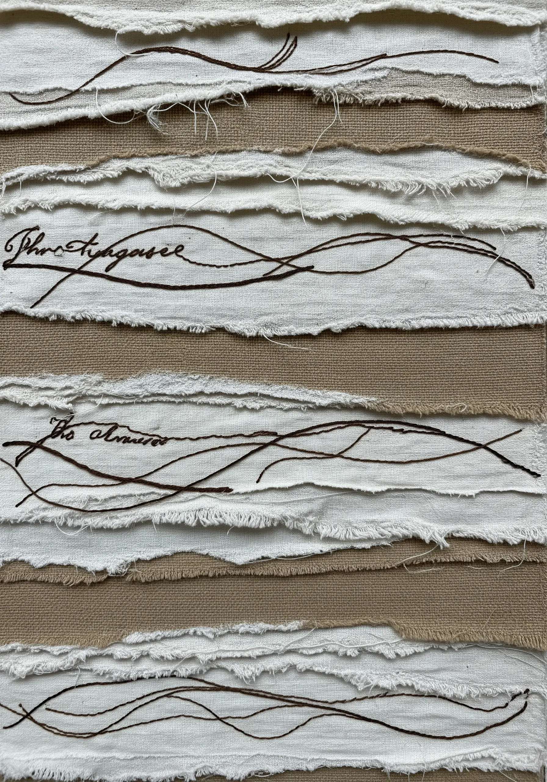 Layered strips of ripped neutral-toned fabric with delicate, free-form script embroidery.