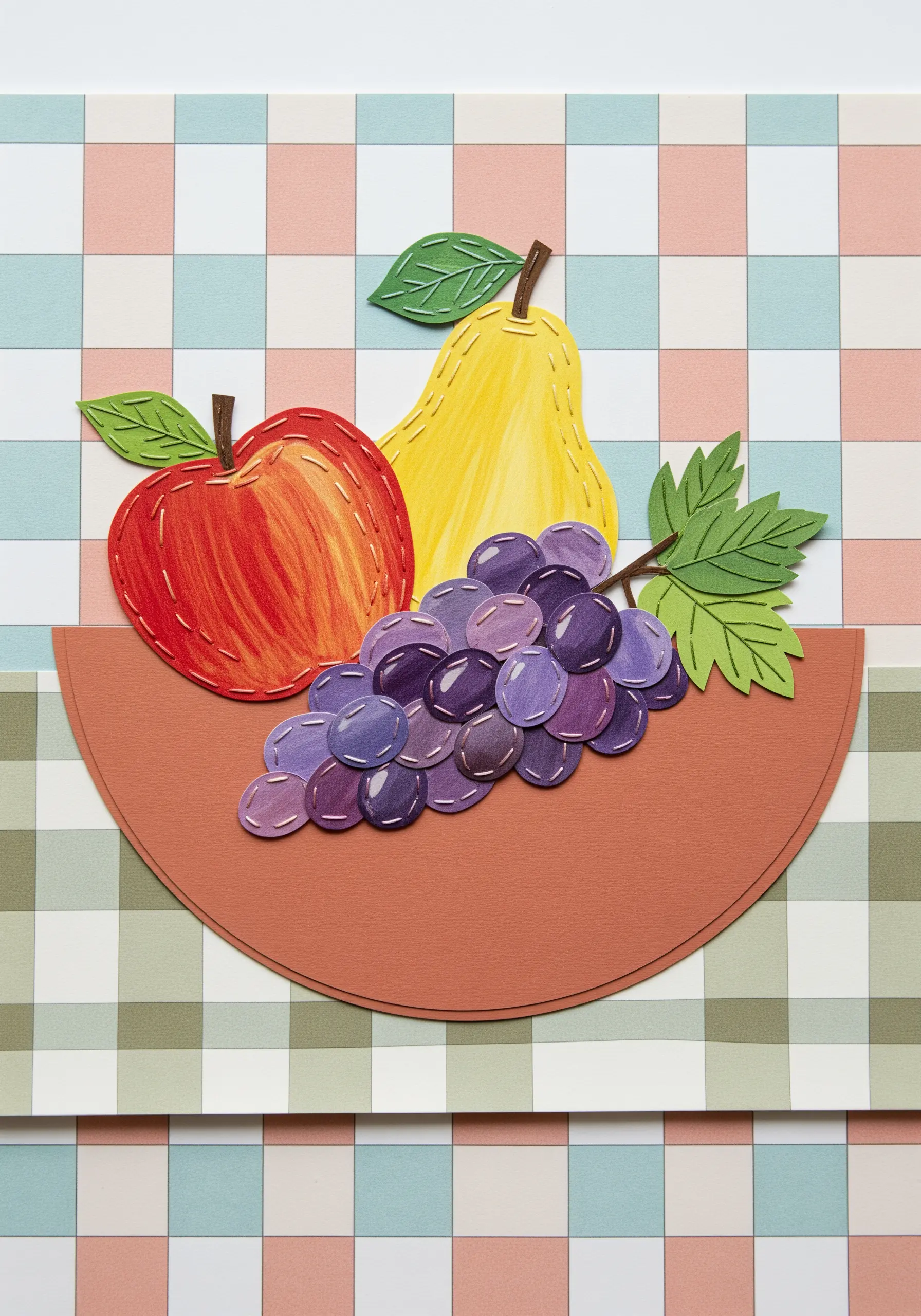 Paper cutouts of an apple, pear, and grapes with realistic shading added through thread painting.