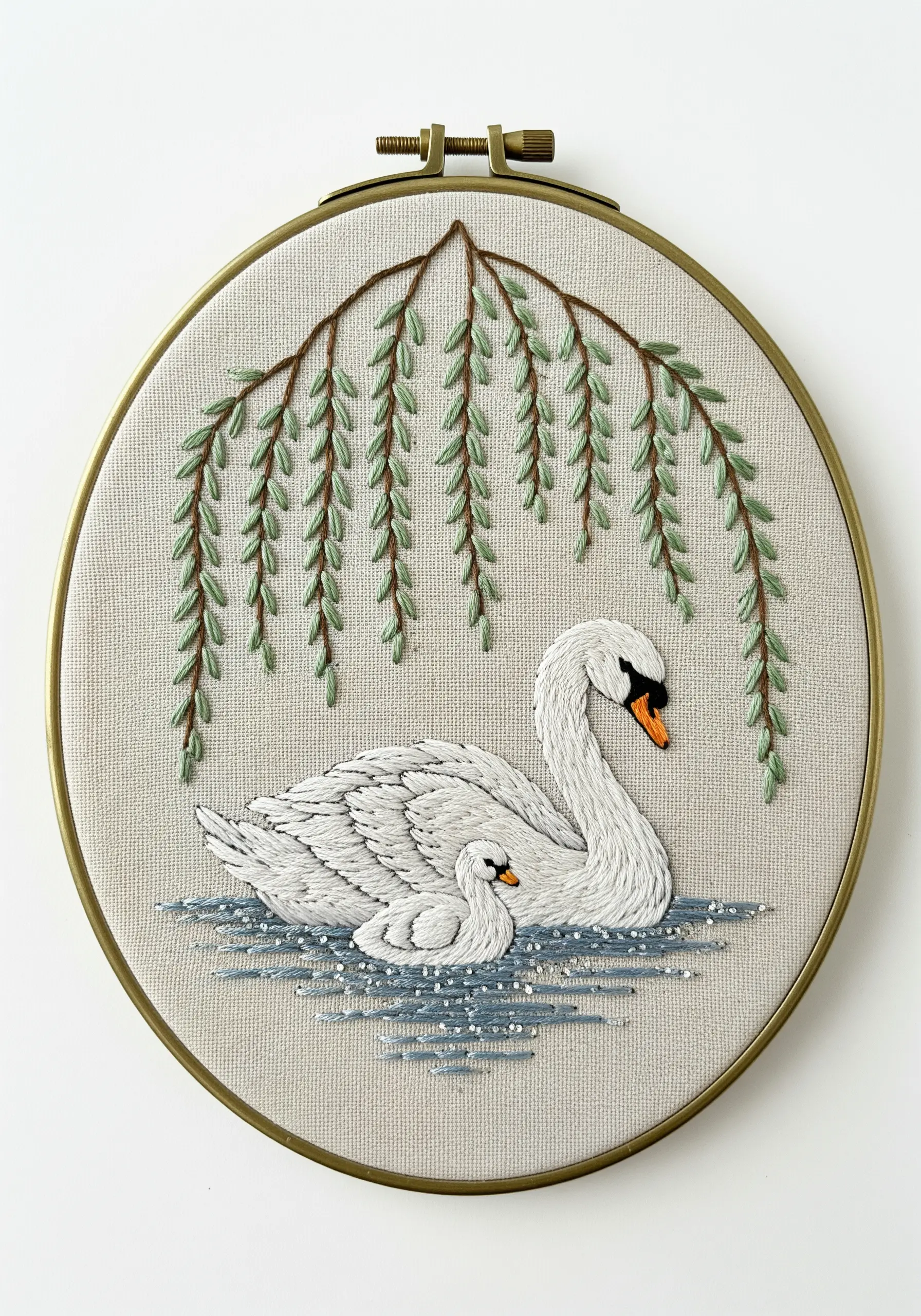 Embroidered swan and cygnet under a weeping willow tree, with metallic threads in the water.