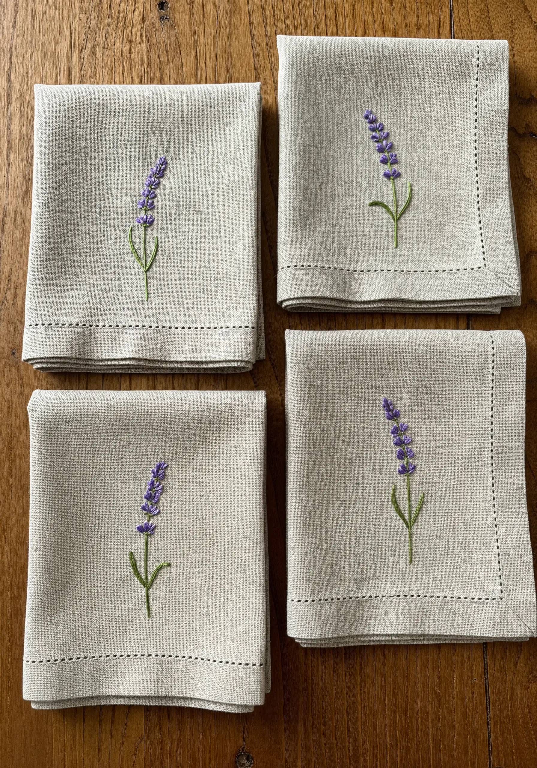 Linen napkins with a single sprig of lavender embroidered on each and a dark running stitch border.