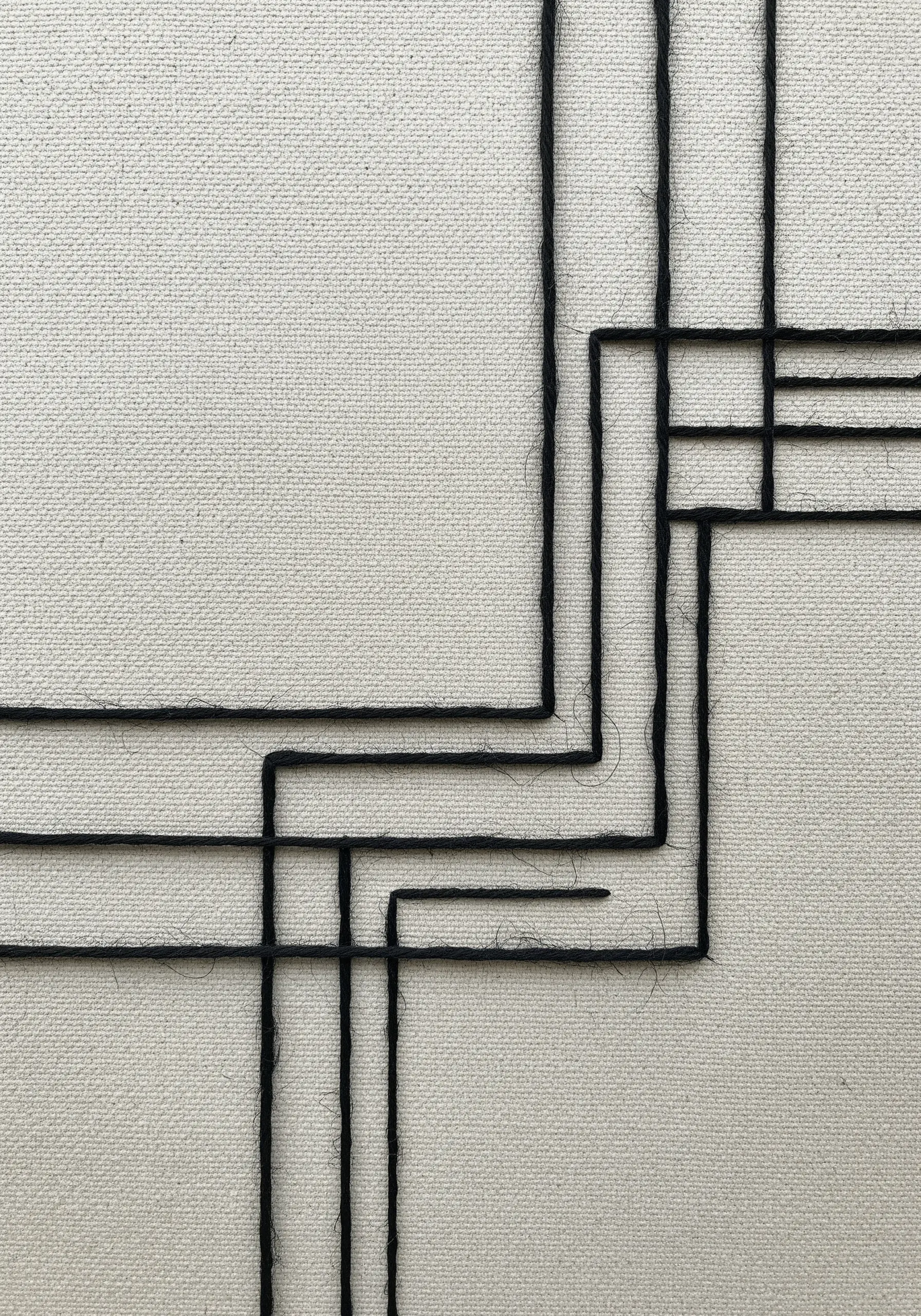 Minimalist geometric design made with thick black yarn couched onto white canvas.