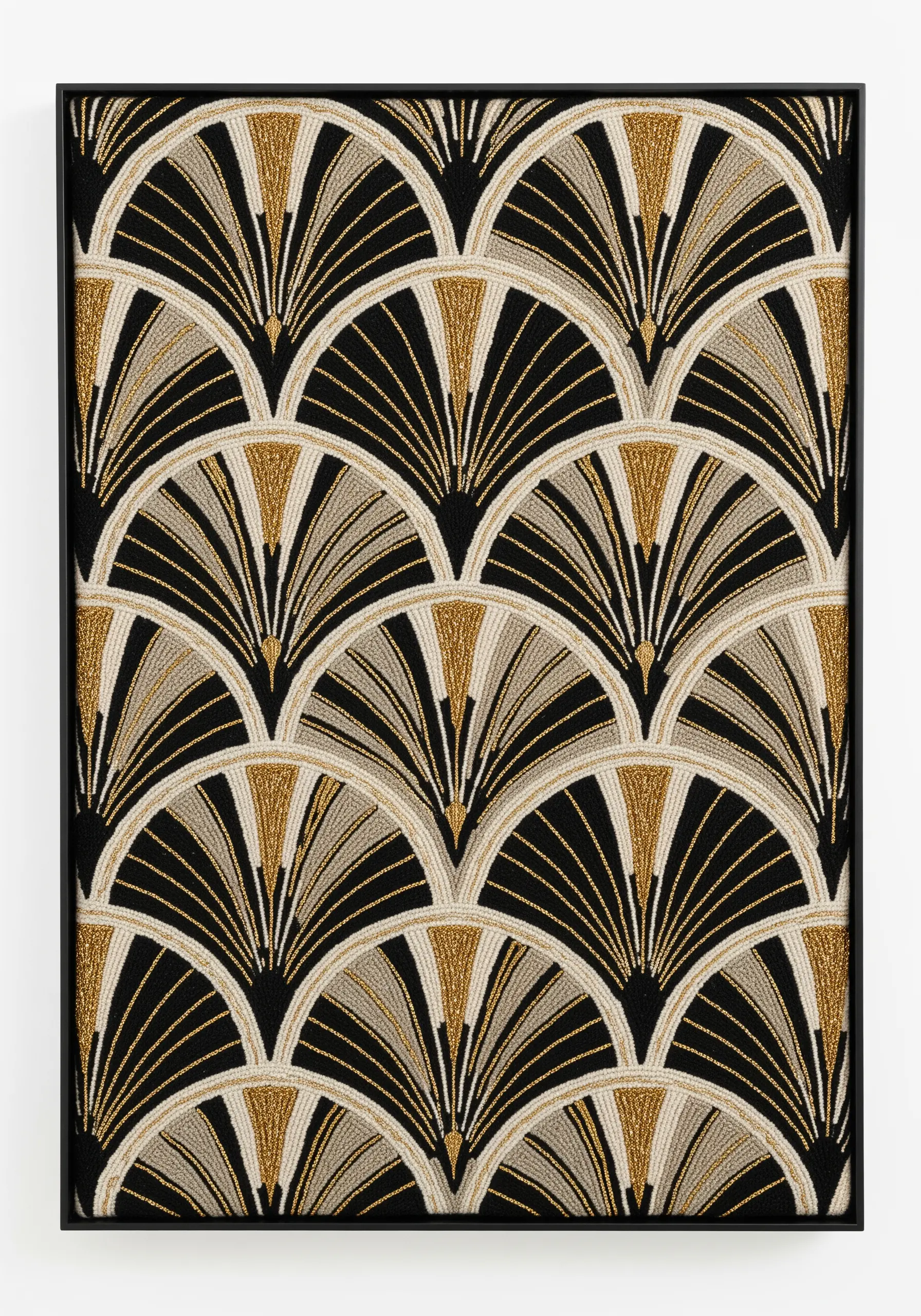 A framed piece of embroidery with a repeating Art Deco fan pattern in black, gold, and cream.