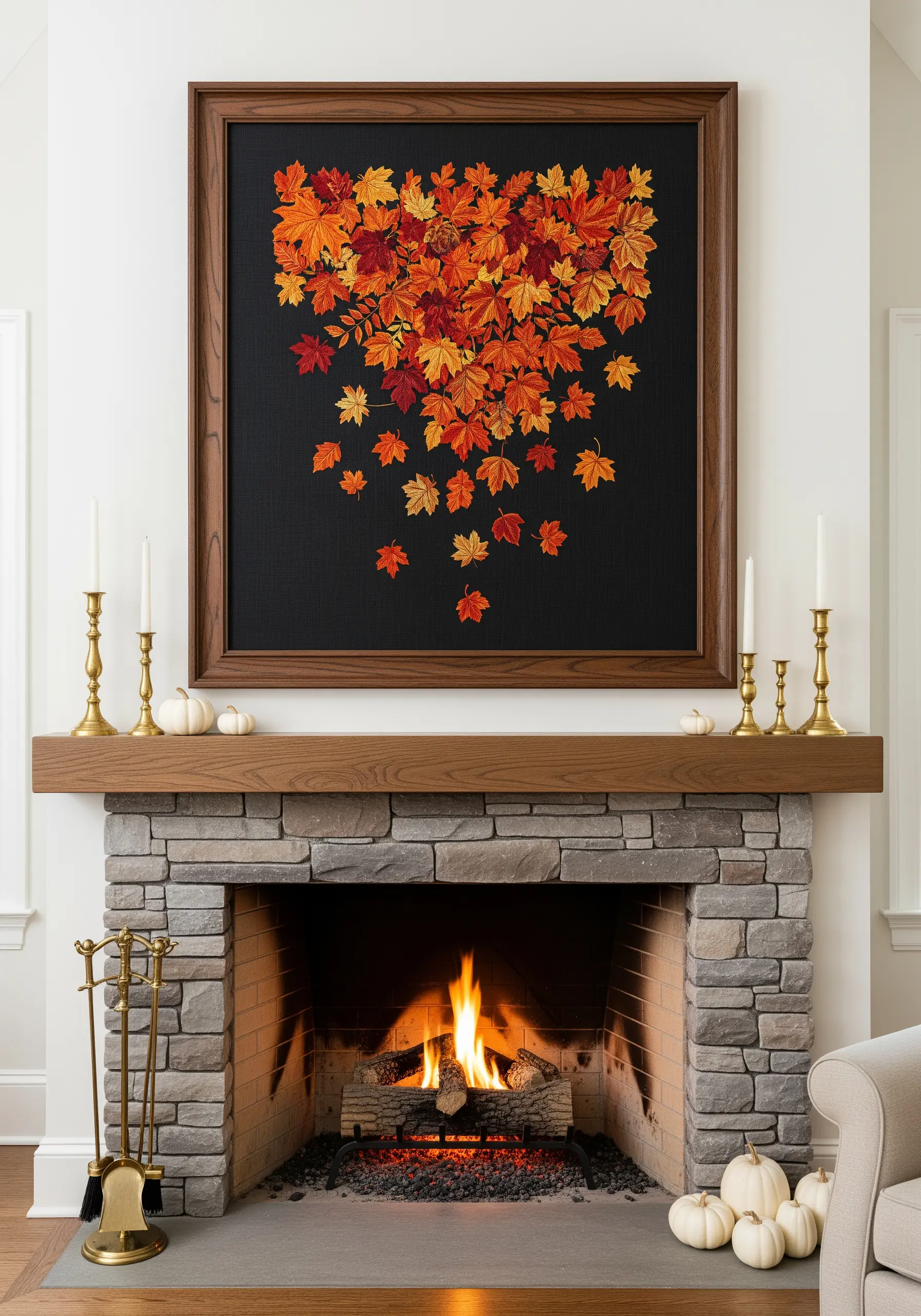 Embroidery of falling autumn maple leaves in warm oranges and reds on black fabric above a fireplace.